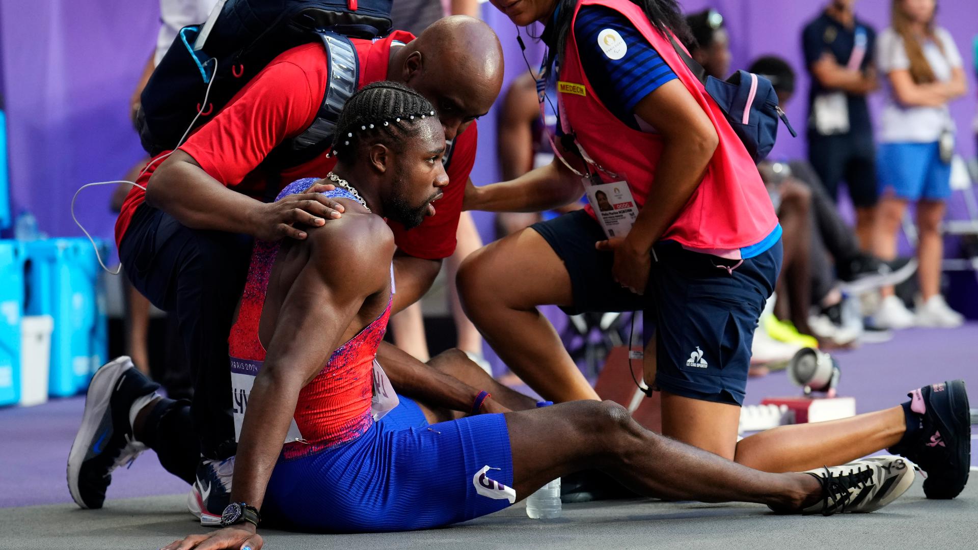 After crossing the line third in the 200 meters for the second straight Olympics, Noah Lyles fell to his back and sat up to be tended to by medical staff.