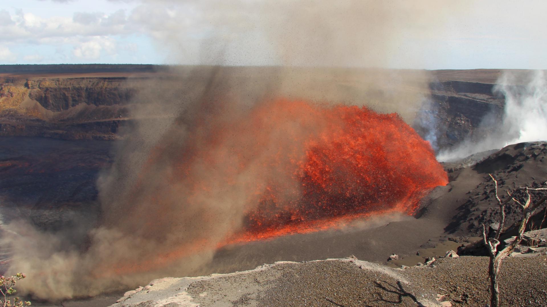 Hawaii's Kilauea volcano resumed erupting Friday by shooting an arc of lava 100 feet into the air and across a section of its summit crater floor.