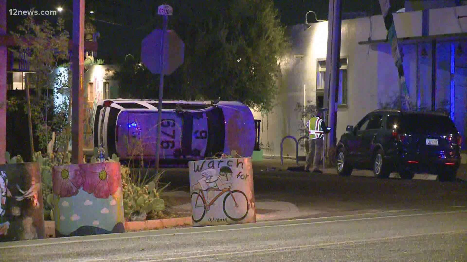 A Phoenix Police cruiser is on its side after a crash near the intersection of 13th and Grand avenues early Wednesday.