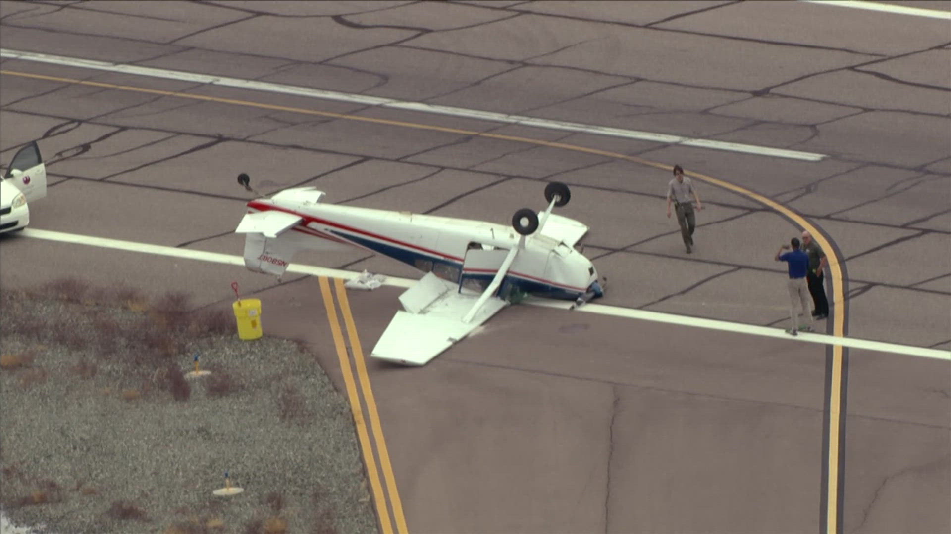 Sky12 is over the scene near Deer Valley Airport where a plane is upside down.