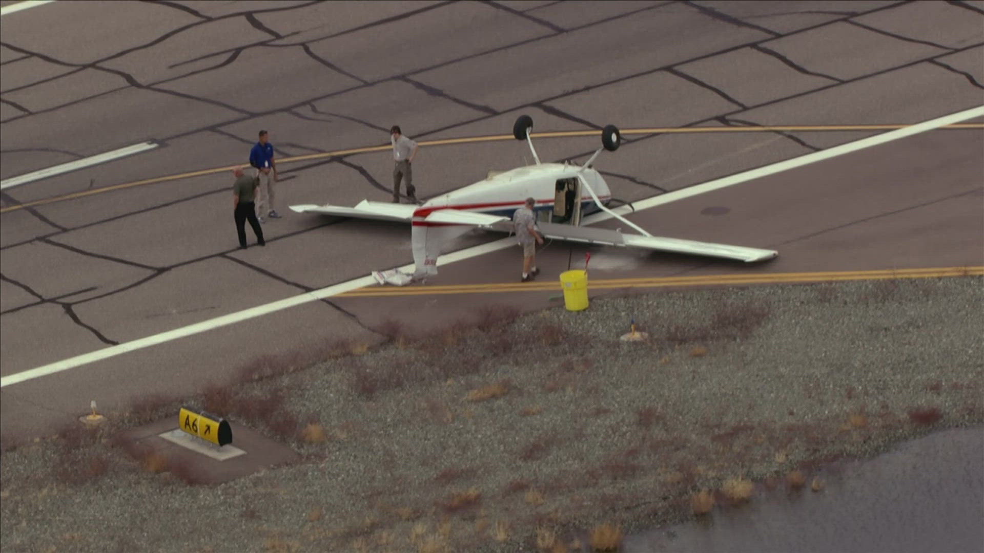 Sky12 is over the scene near Deer Valley Airport where a plane is upside down.