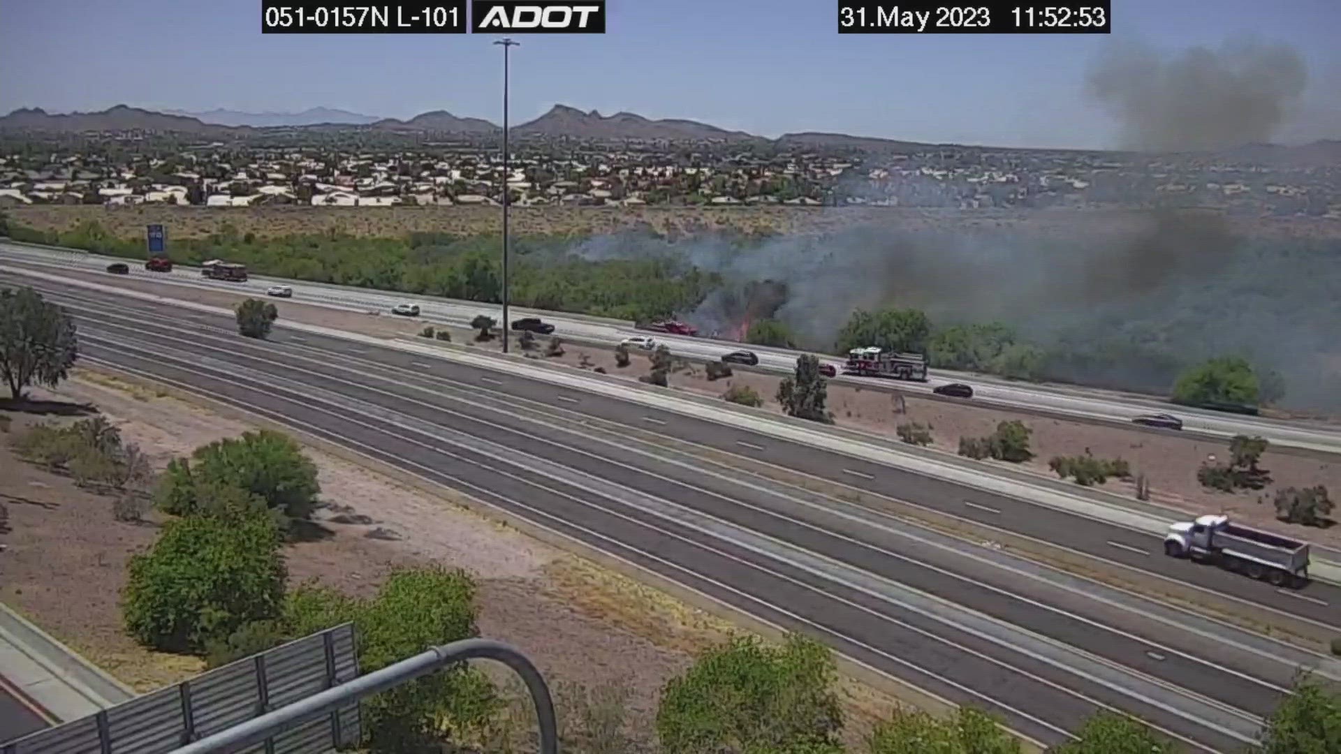 Highway cameras from the Arizona Department of Transportation show small flames and moderate smoke.