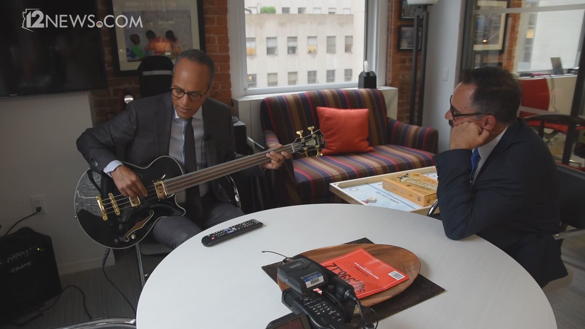 Lester Holt shows Mark Curtis his skills on the bass