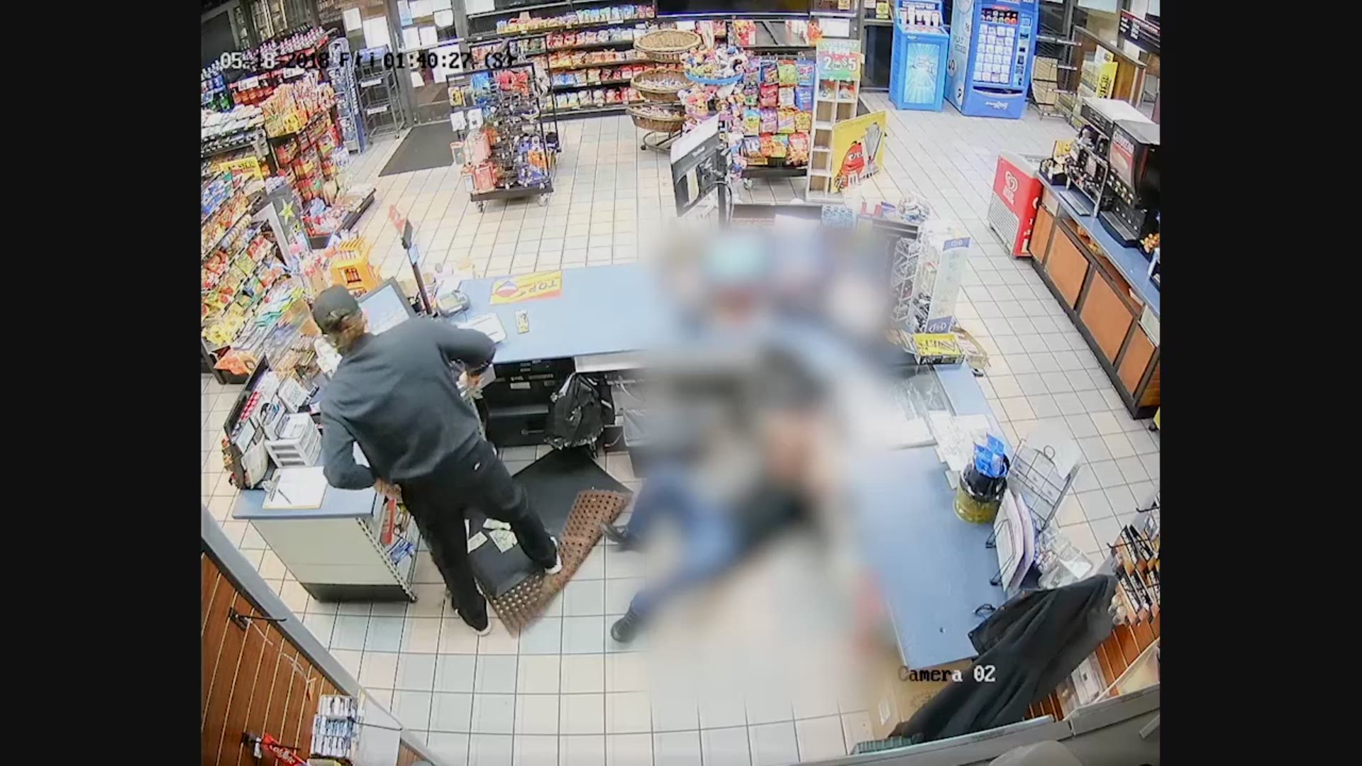 Suspect punches clerk on face to rob him.