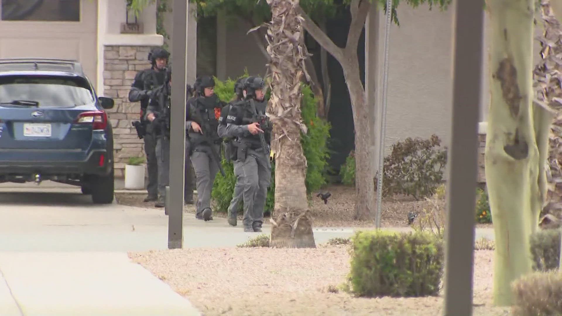 Officers from Gilbert and Queen Creek were gathered together, according to a 12News photographer at the scene.