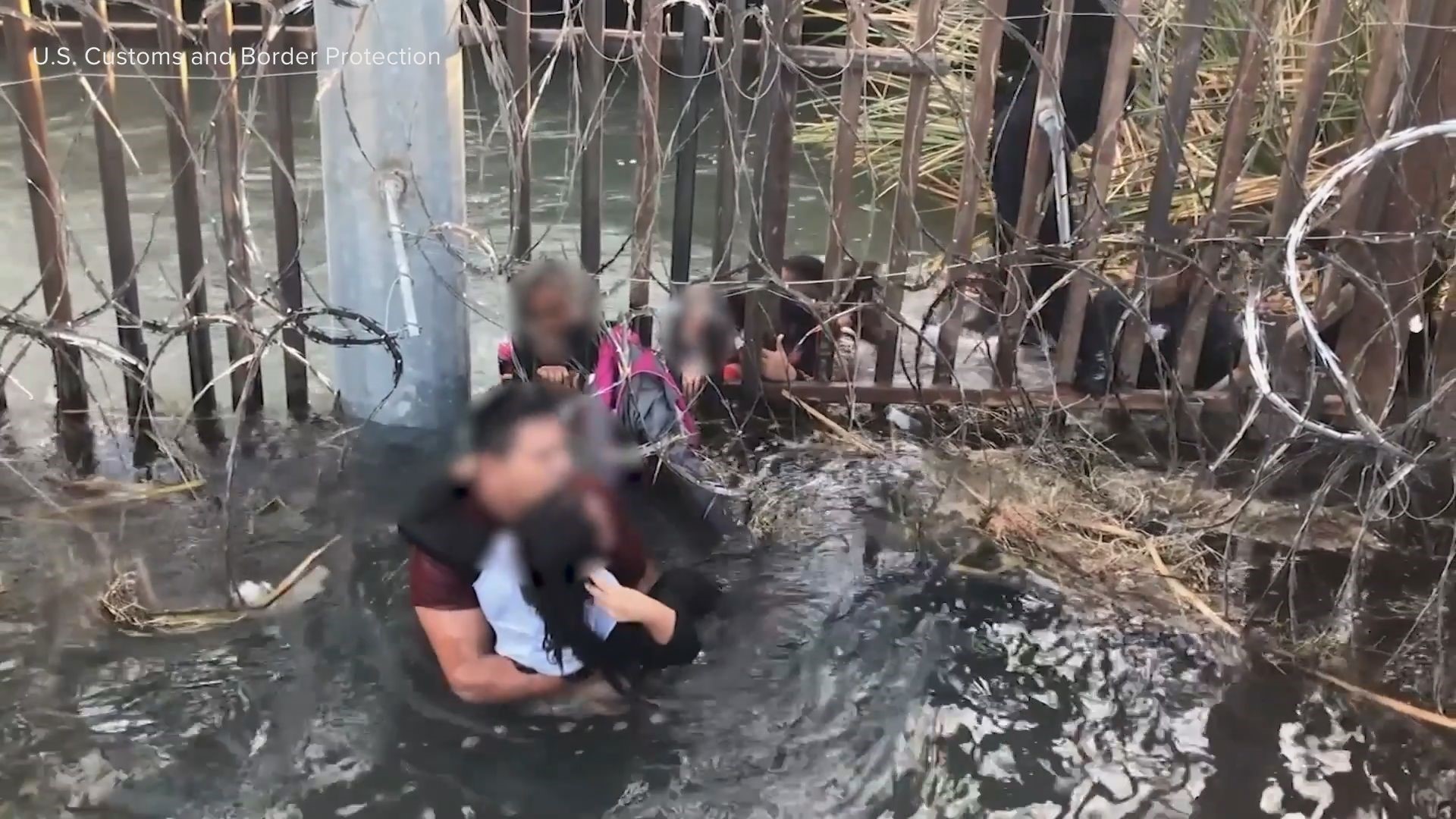 In the videos, migrant smugglers are seen pushing adults and children through holes under barriers and past large coils of razor wire at the border in Yuma, Arizona.