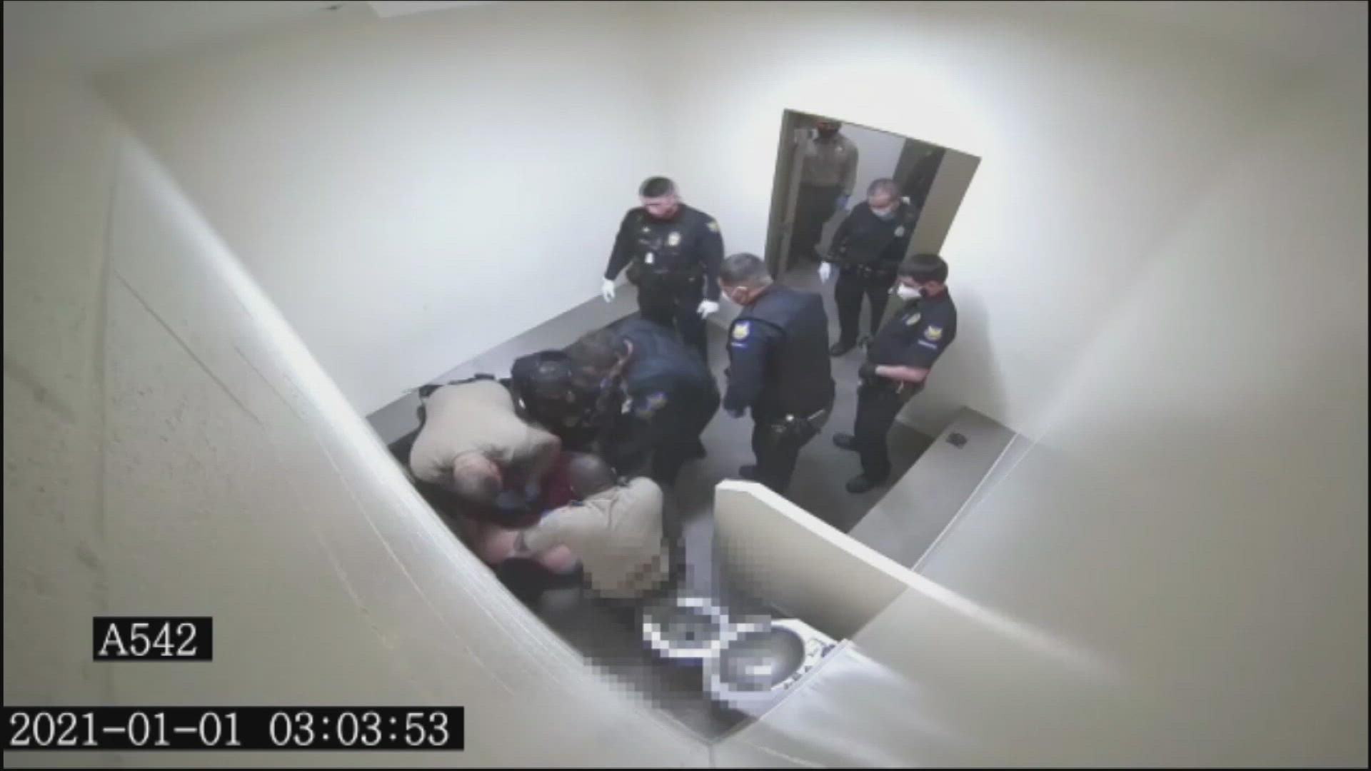 The man's family contends newly released body camera footage shows officers filing out of the cell, leaving him motionless and face down on the floor.