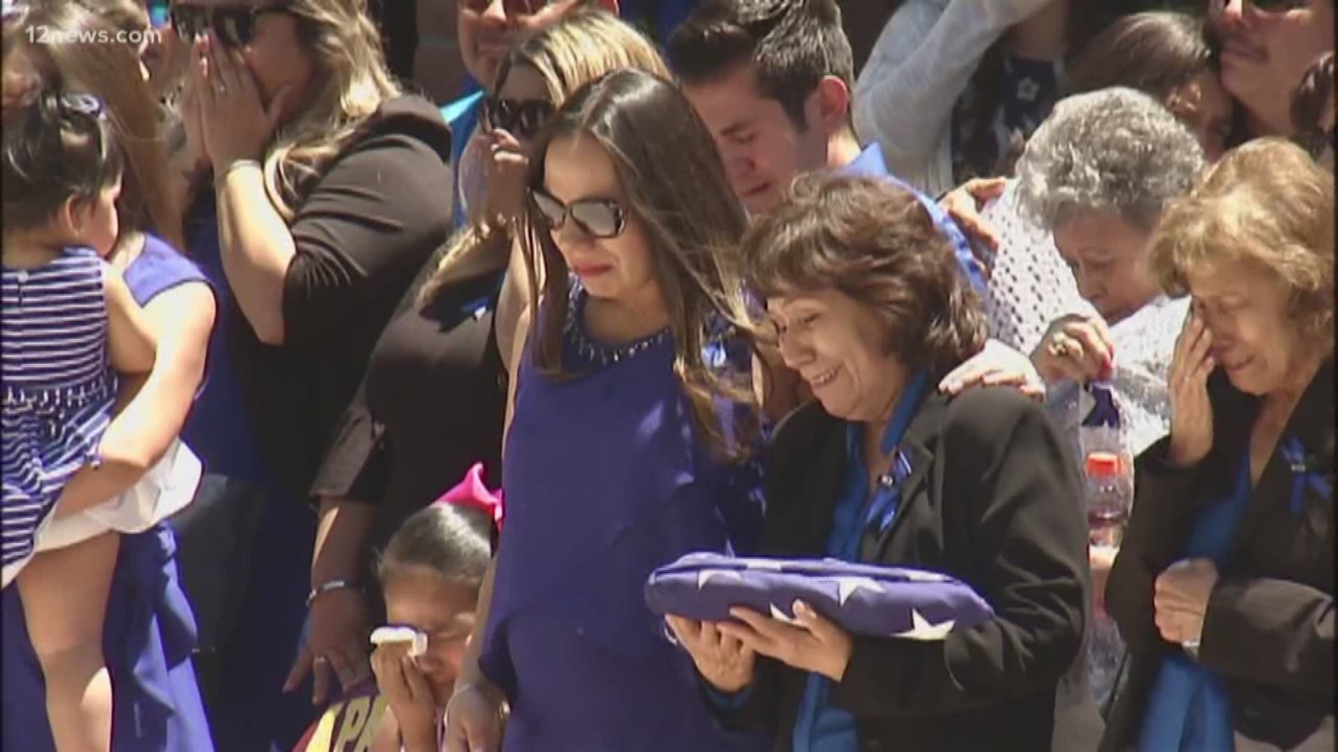 Law enforcement officers from around Arizona were among over 1,000 people who attended a Mass to honor and bid farewell to a Nogales police officer fatally shot while trying to arrest a carjacking suspect.