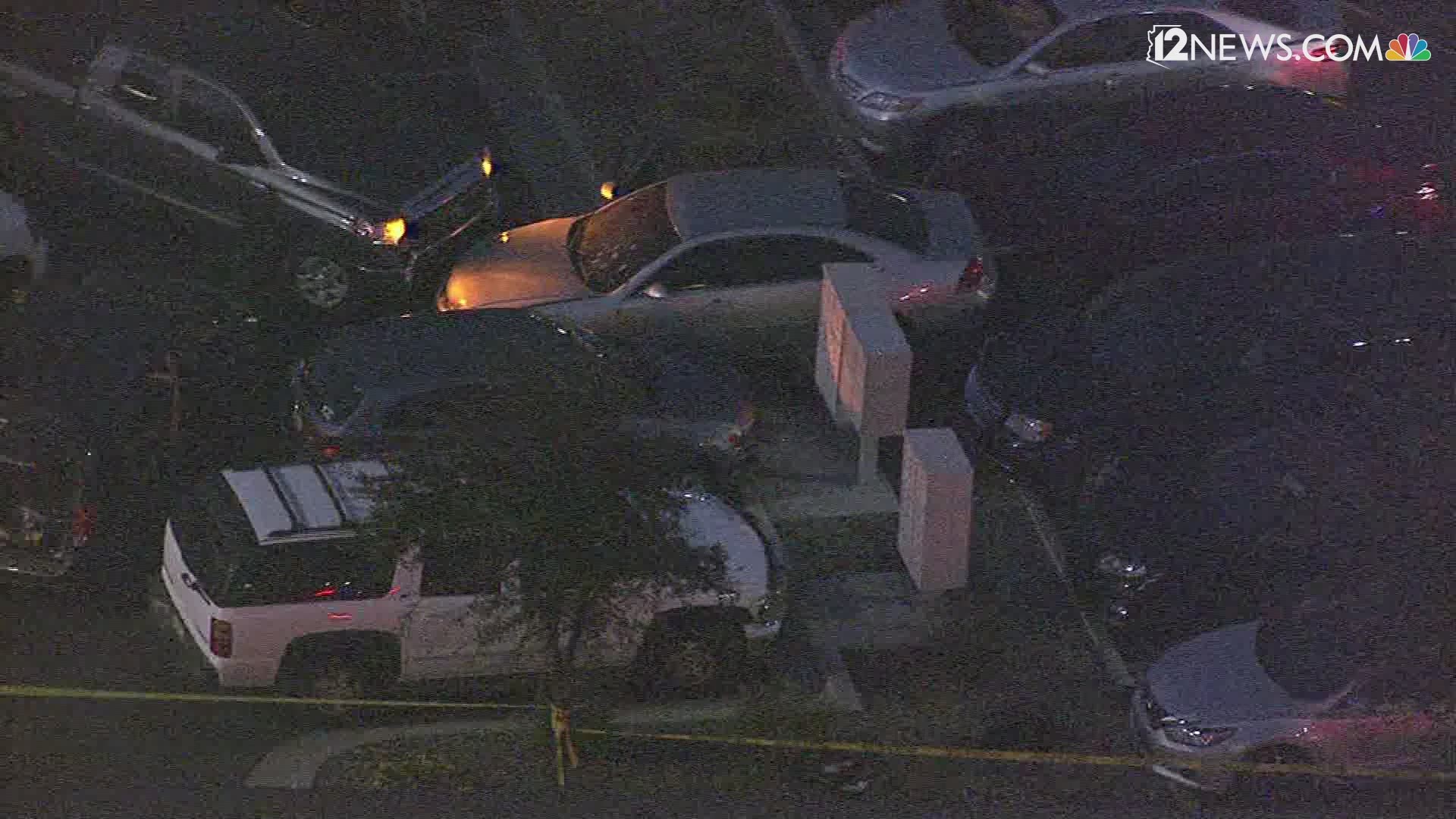 Sky 12 video shows bullet holes in a car's windshield. Police vehicles surrounded the car.