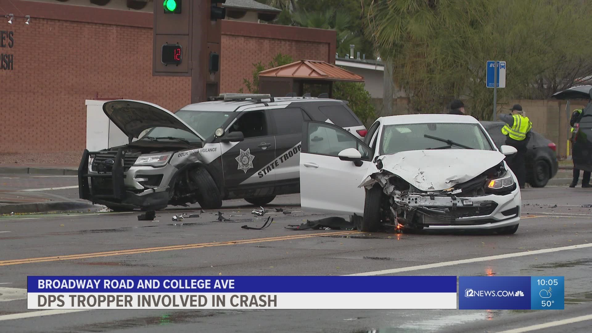 A DPS officer as been taken to the hospital after their vehicle was hit by a driver who ran a red light, police say.