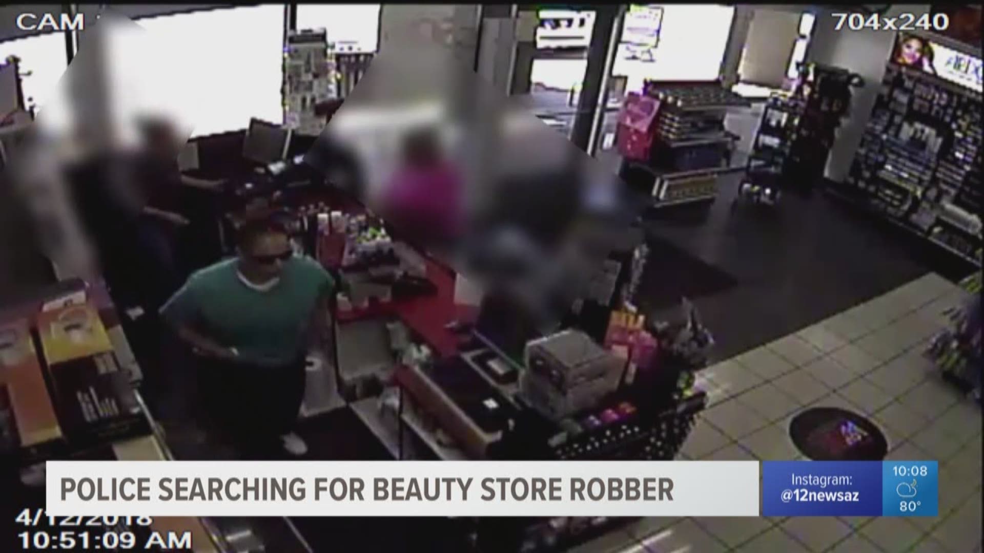 A suspect simulates a gun in her waist band while demanding money at a beauty supply shop in Phoenix.