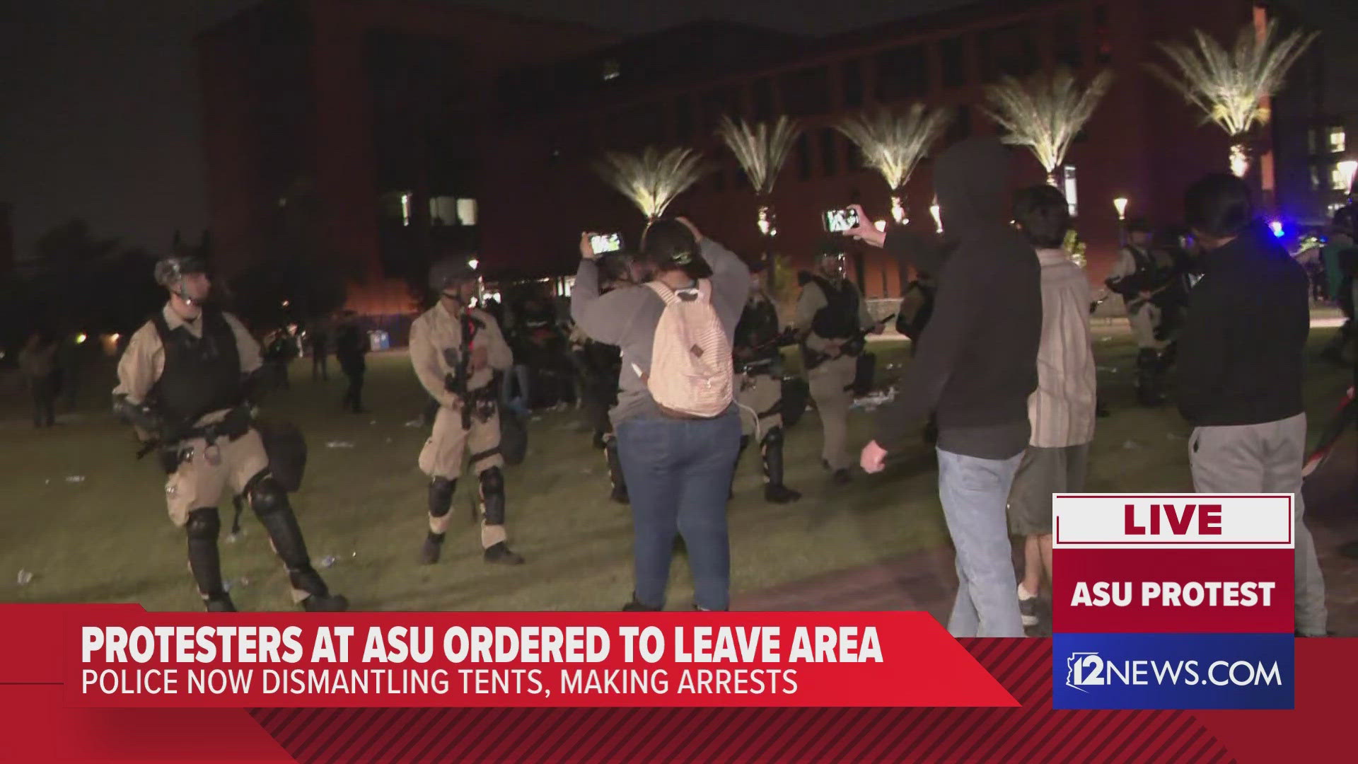 Arizona state troopers push protesters back as they try to break up a protest outside of Old Main on ASU's Tempe Campus