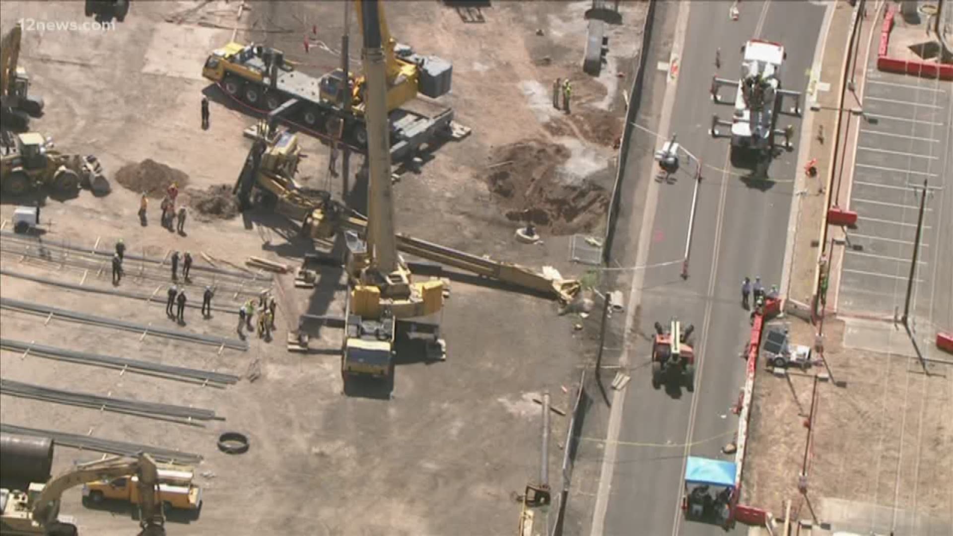 A toppled drill rig has been removed from a collapsed 32-foot hole near Phoenix Sky Harbor International Airport, but crews have yet to recover the body of a missing construction worker.