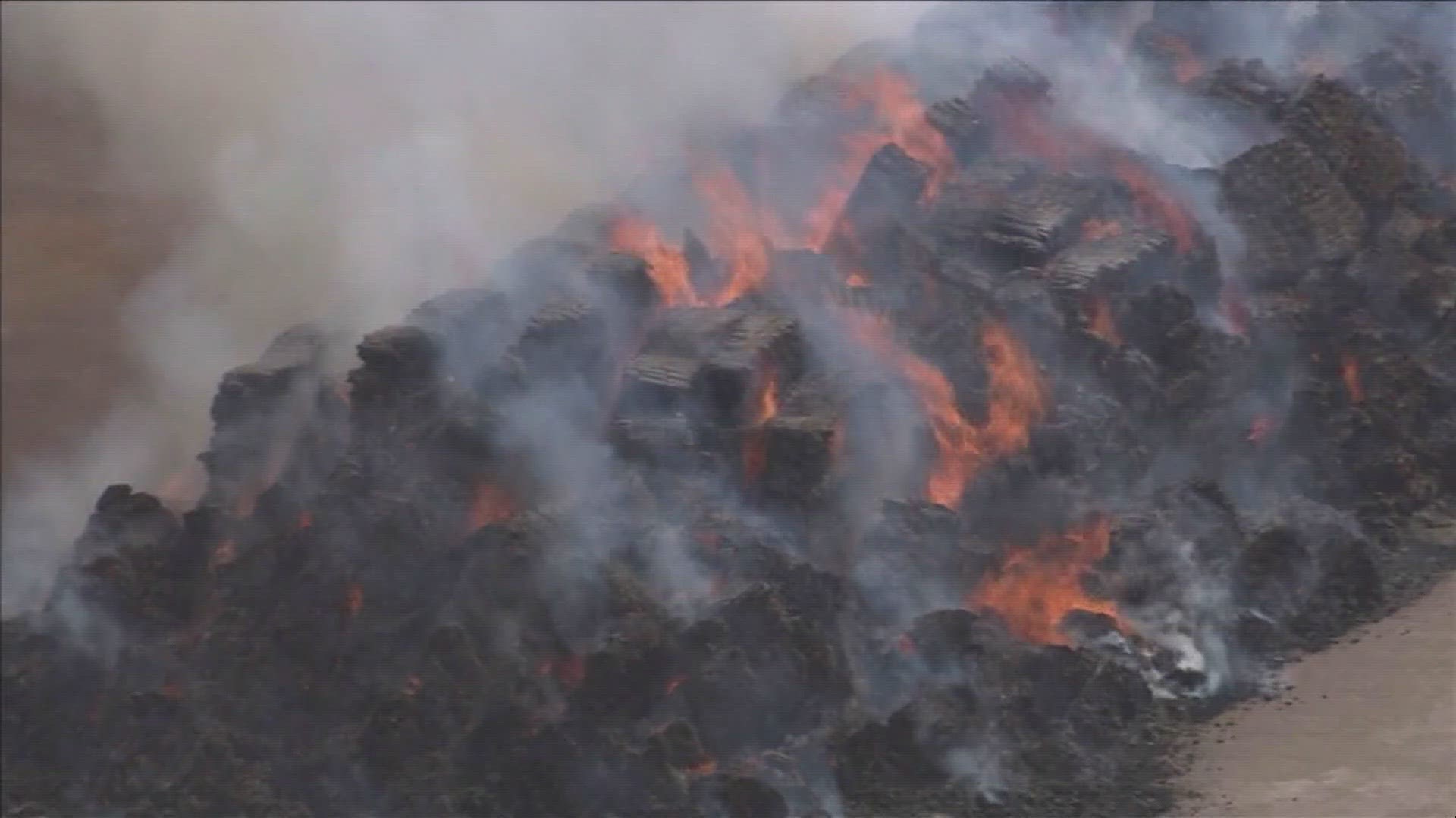 Fire officials warned nearby residents to close windows and doors to their homes while the haystacks burn.