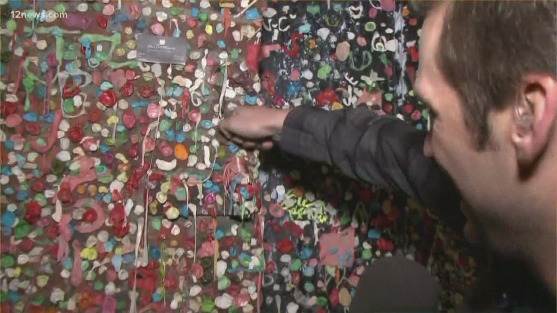 Paul leaves a memento on Seattle's famous Gum Wall.