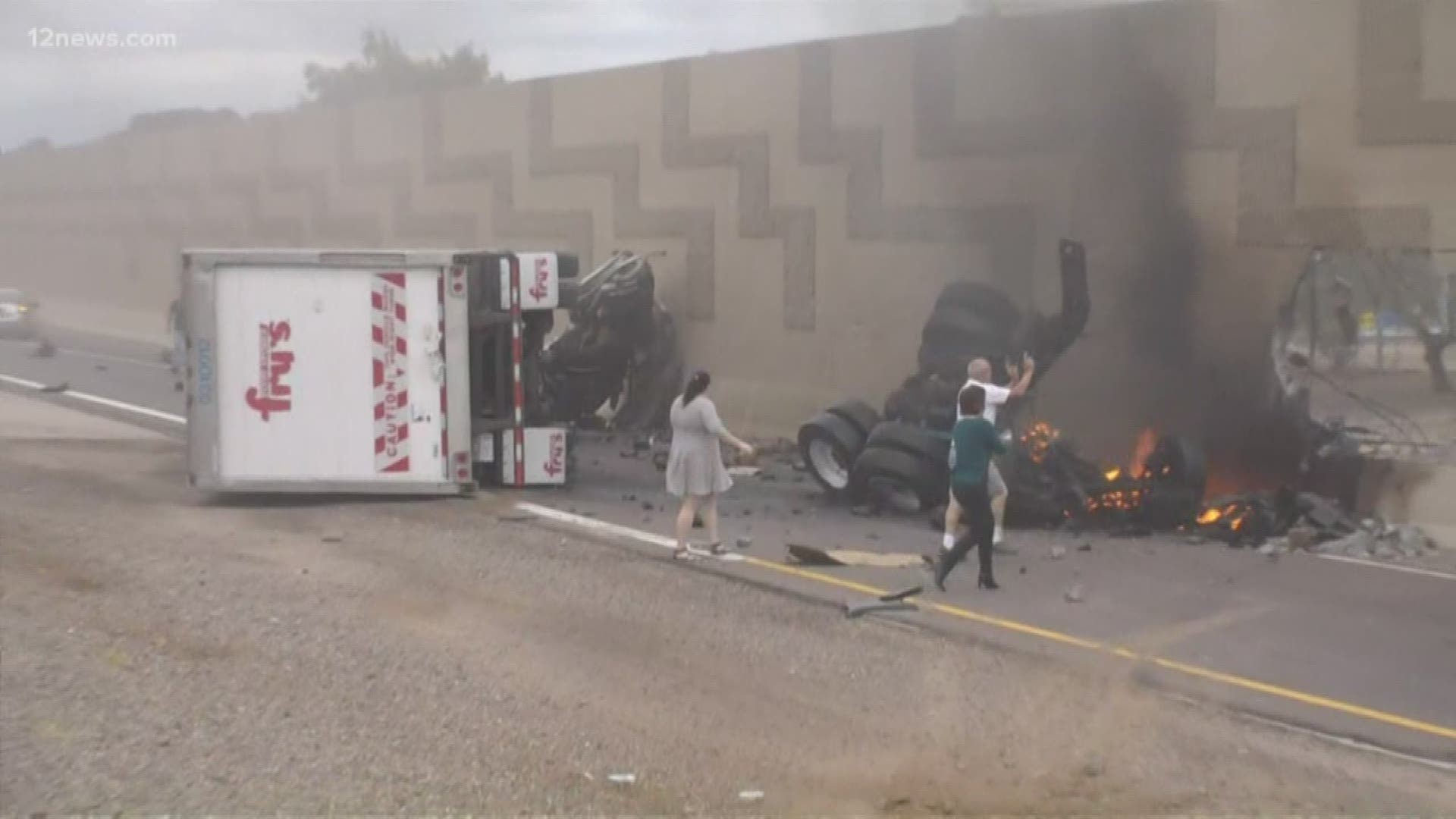 Several bystanders tried to help the driver after a semi-truck crashed on Loop 101 Agua Fria near Peoria Avenue.