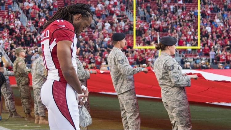 People are asking if pictures of Larry Fitzgerald during the national  anthem are fake