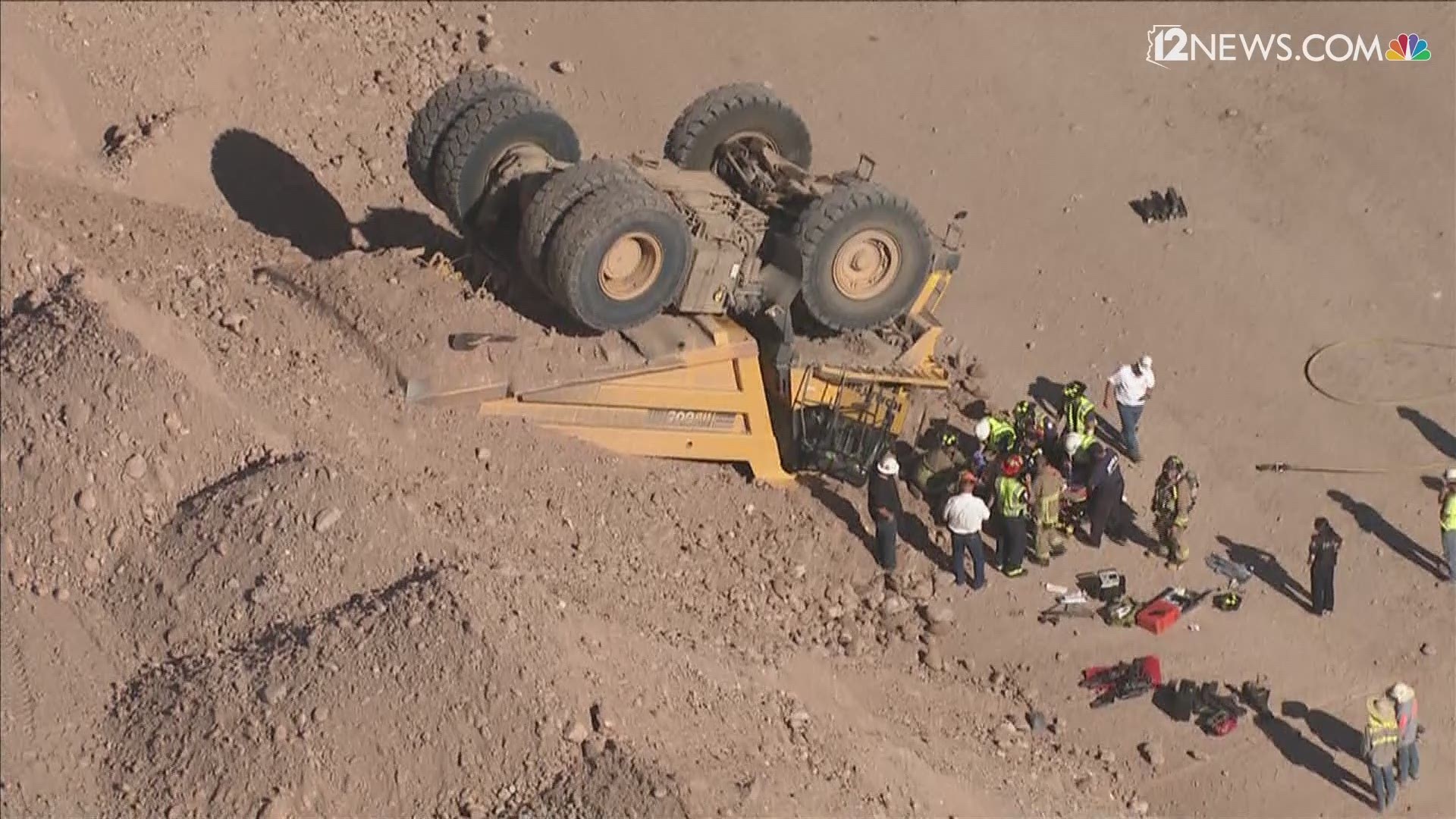 A construction worker in Mesa was freed from an overturned dump truck Thursday afternoon. The worker was flown to a trauma center with life-threatening injuries.