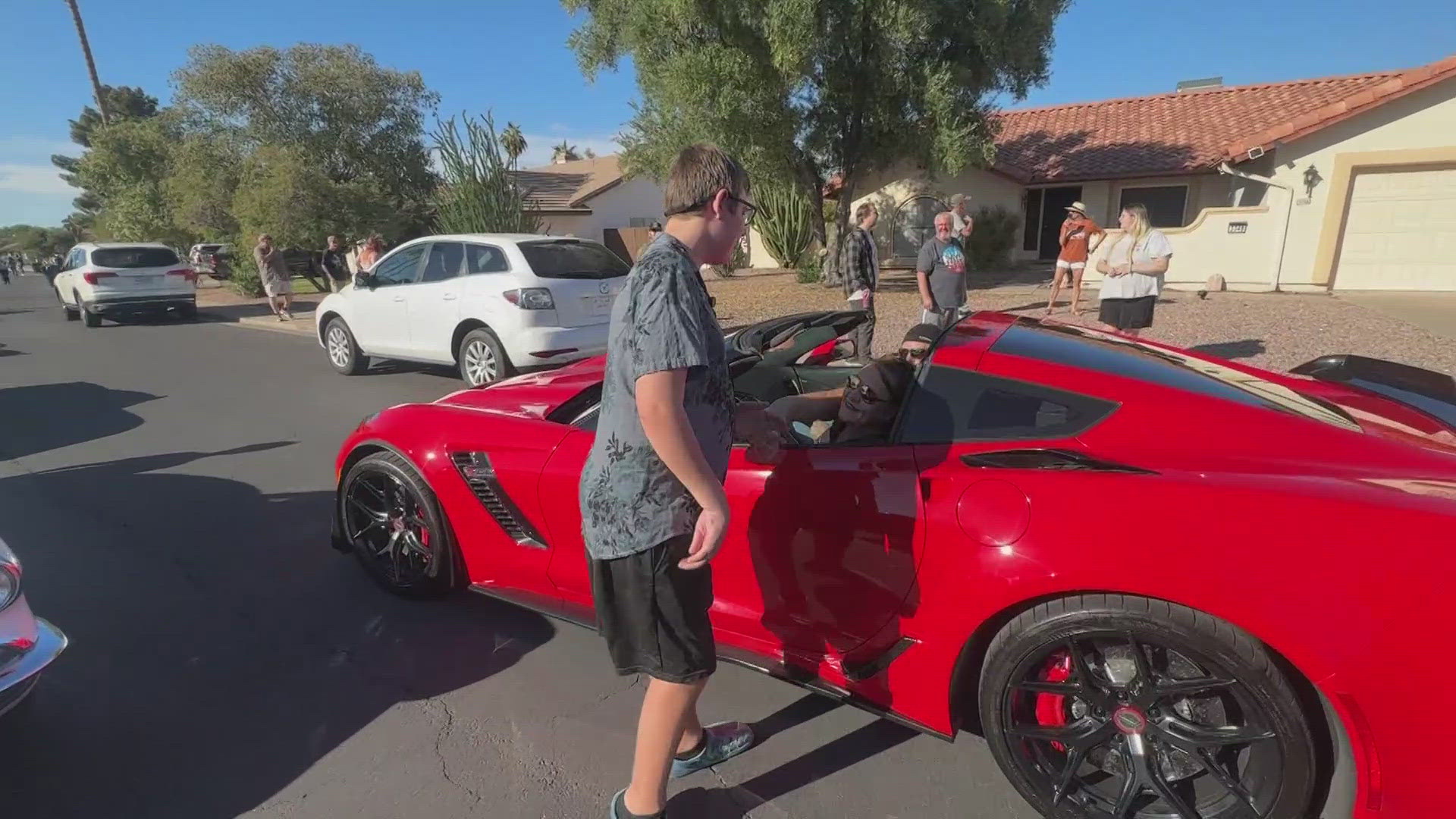 A Valley teenager who loves sports cars got the surprise of a lifetime when dozens of high-performance cars rolled past his house in a special parade.