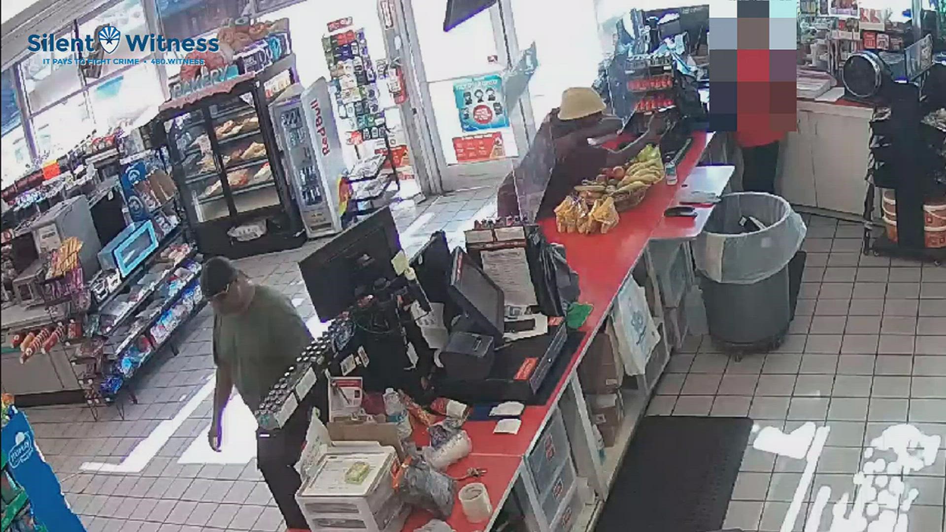 Police are searching for two men caught on camera robbing a convenience store at gunpoint.