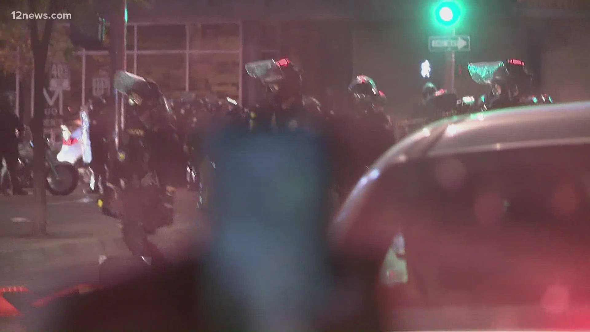 Officers in riot gear confront protesters in downtown Phoenix during Saturday night's protest. Bianca Buono has more.