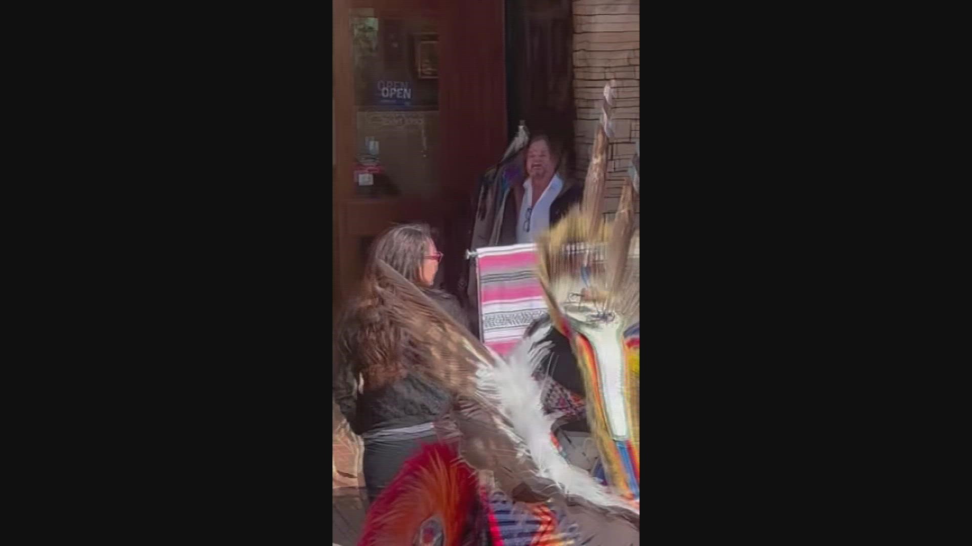 A racial confrontation was caught on camera as the owner of a Native American jewelry store hurled insults at Native American dancers.