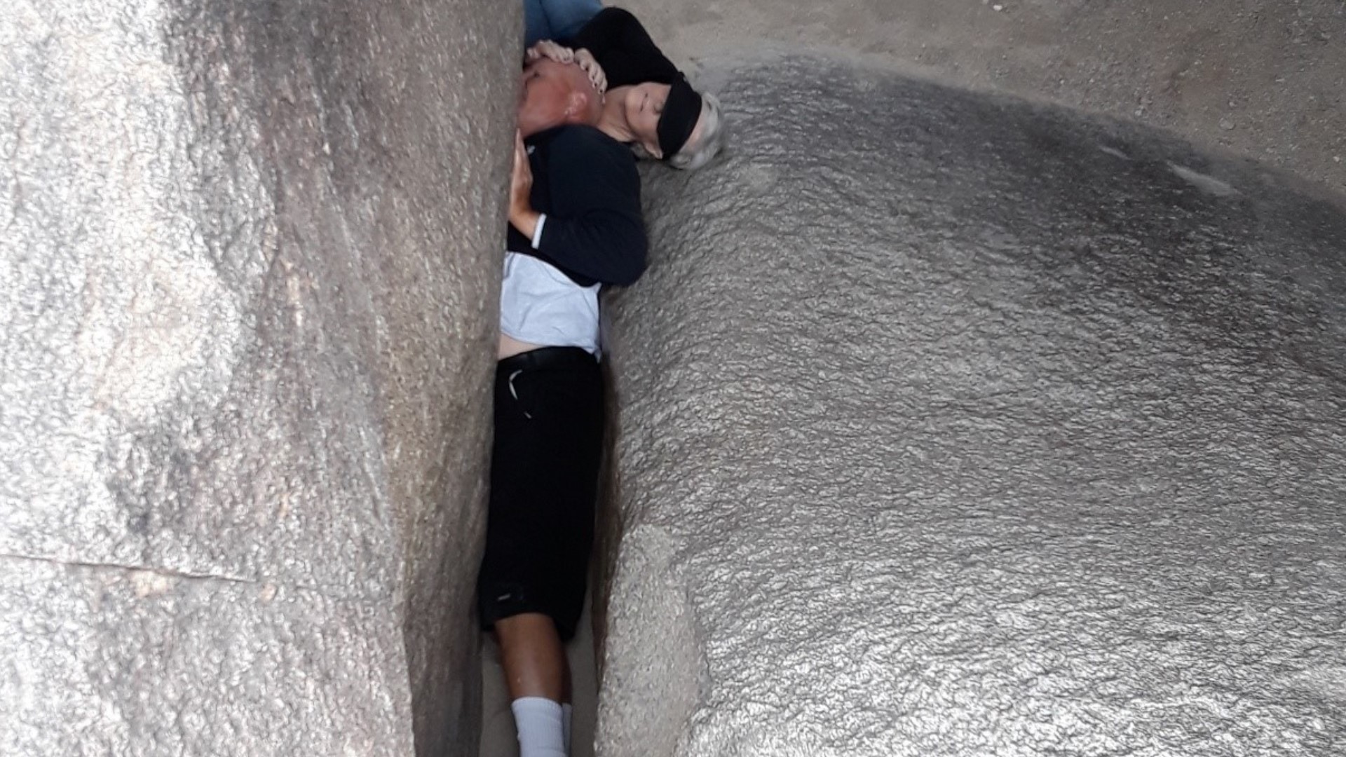 A 50-year-old man was stuck in a small crevice between two massive boulders for close to an hour on Thanksgiving.