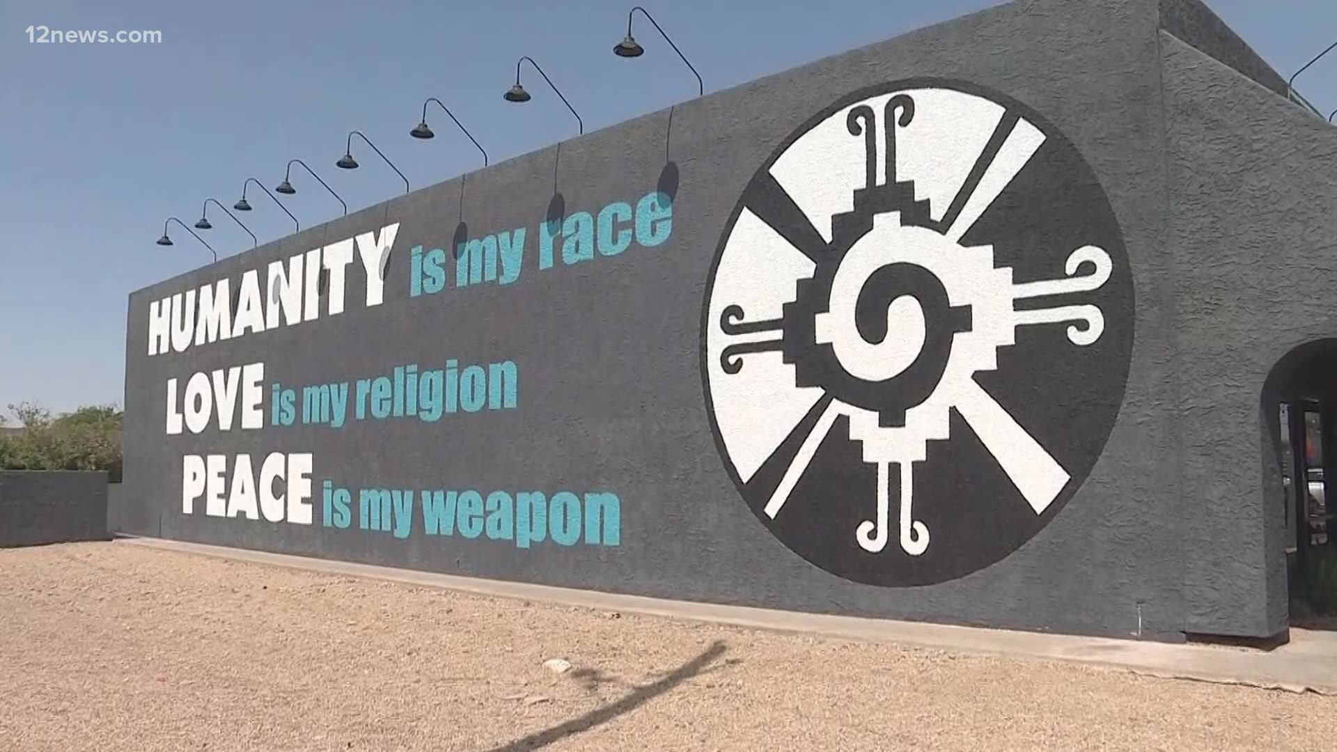 The kind gesture is painted in the form of a mural at The Tamale Store in Phoenix. It reads, "Humanity is my race. Love is my religion. Peace is my weapon."