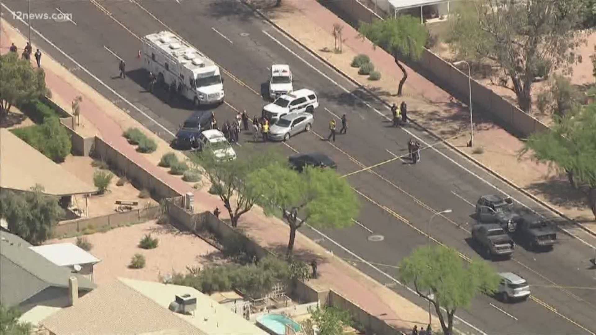 Phoenix police say a woman who was in the suspect vehicle during the shootout died.