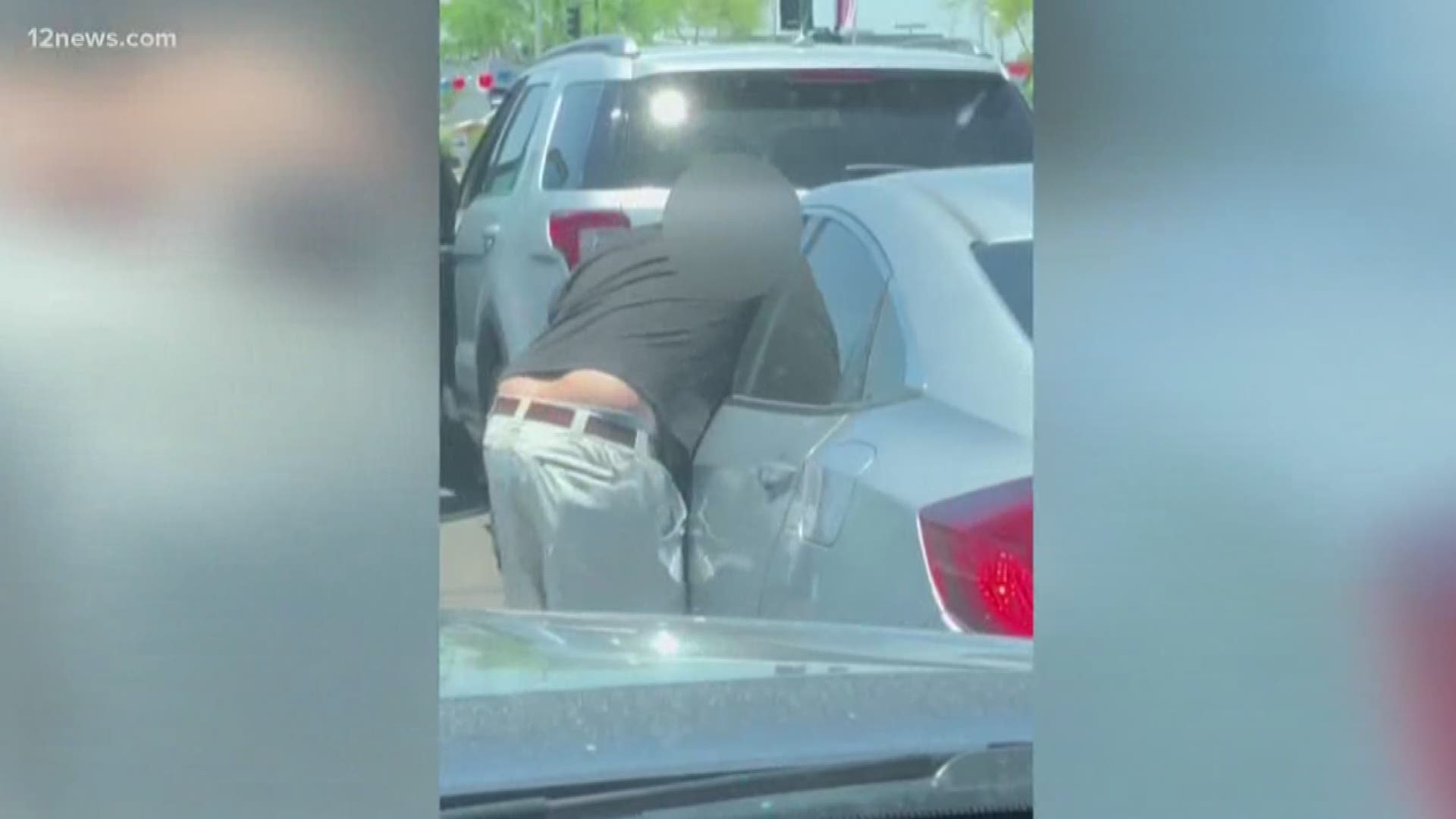 A road rage incident turned violent at a red light in Phoenix, and the confrontation was caught on camera. The video shows a man getting out of his car to confront the person behind him, then throwing punches through the driver's side window.