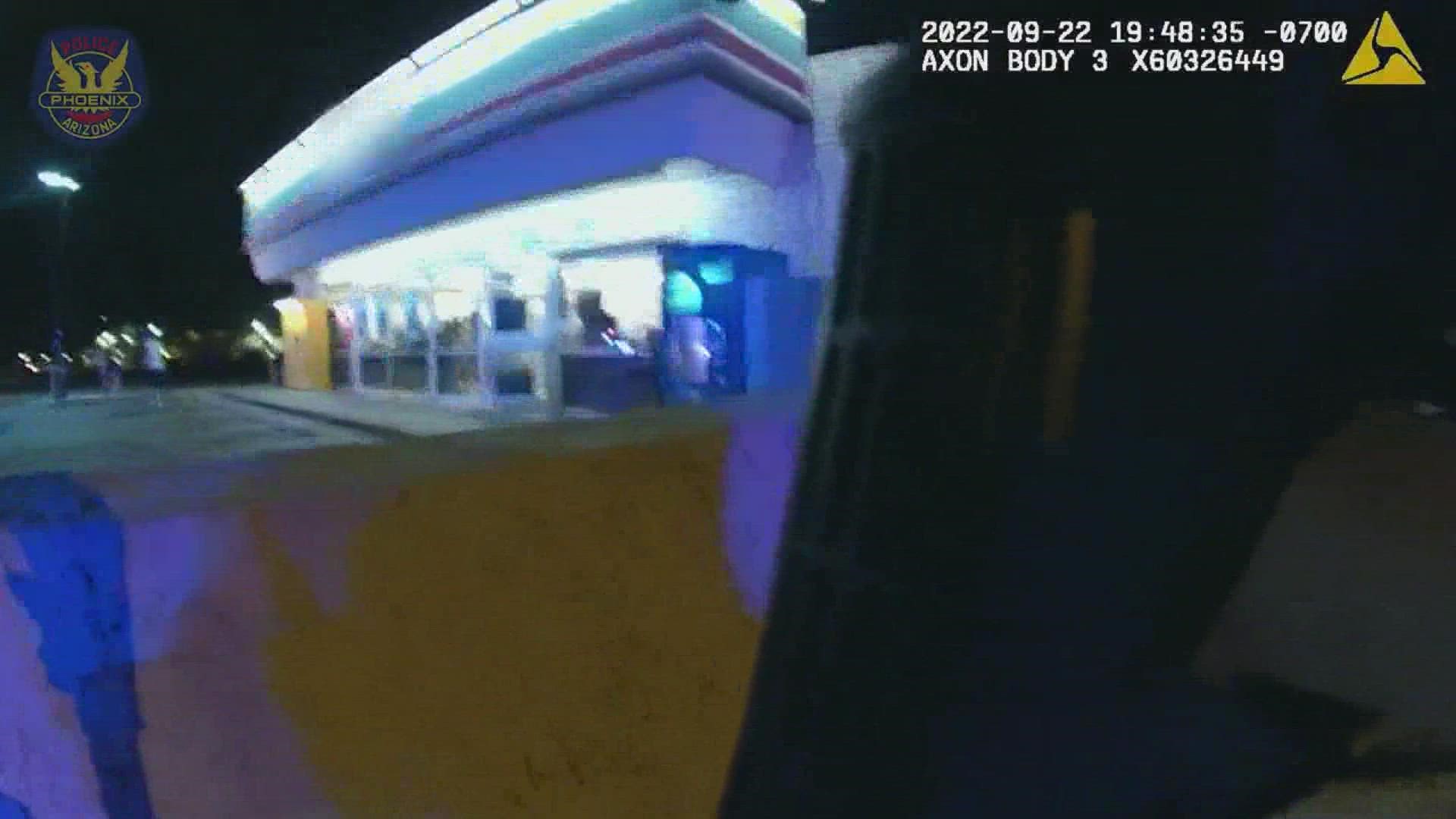 Customers of a 7-Eleven are seen on video running for shelter after Phoenix police officers shot at an armed suspect who entered the store last month.