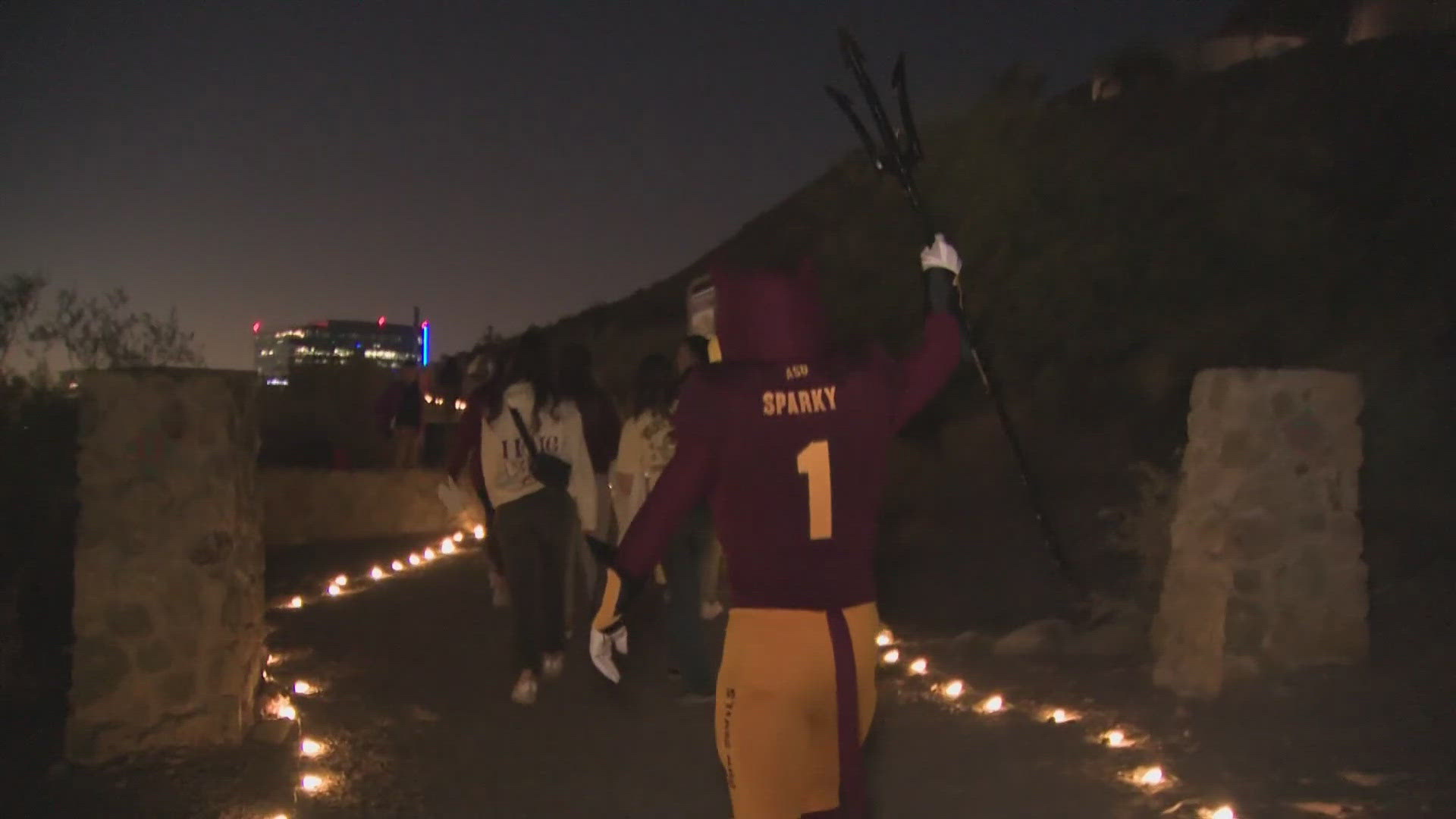 Students walk to the top of A Mountain to crown their homecoming court in the more than 100-year-old tradition.