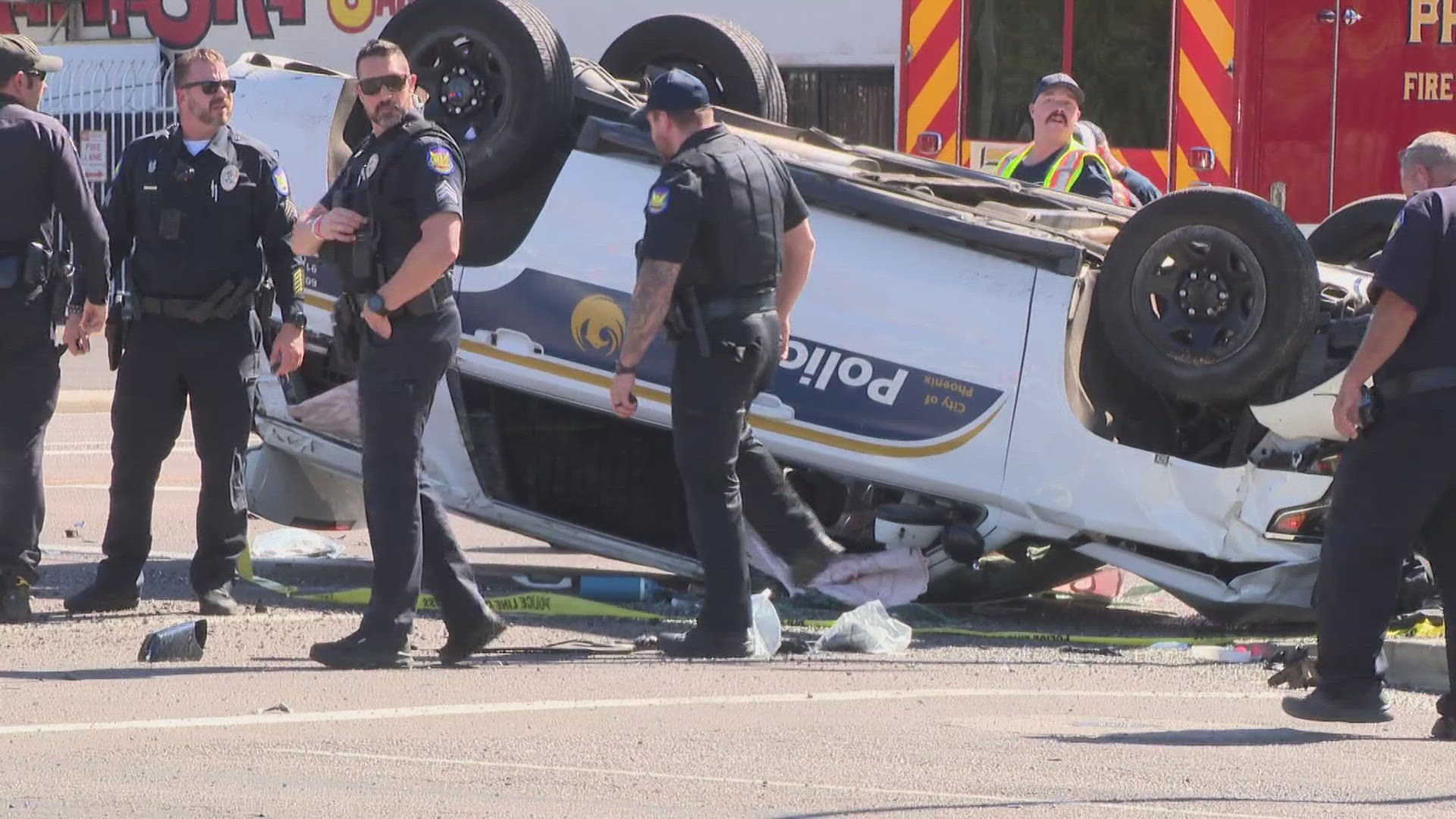 Two officers and a passenger were hospitalized after a rollover crash in downtown Phoenix, according to officials with the Phoenix Police Department. 
