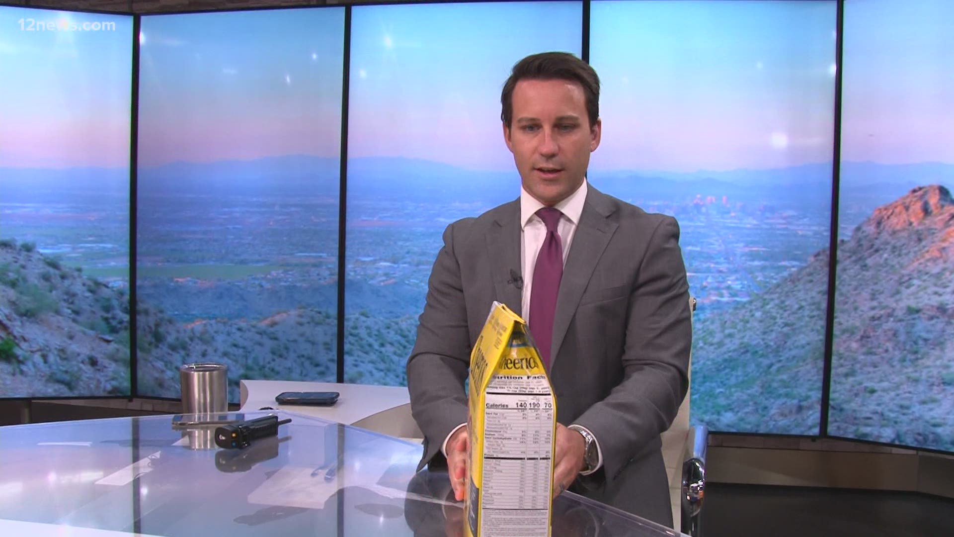 Team 12's Ryan Cody tries cereal box closing trick.