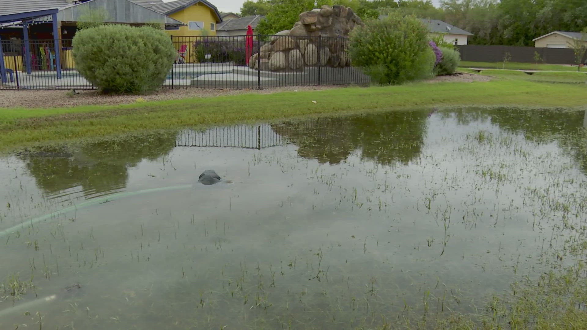 A family in the East Valley battles flooding after heavy rain pours into their home early Sunday.