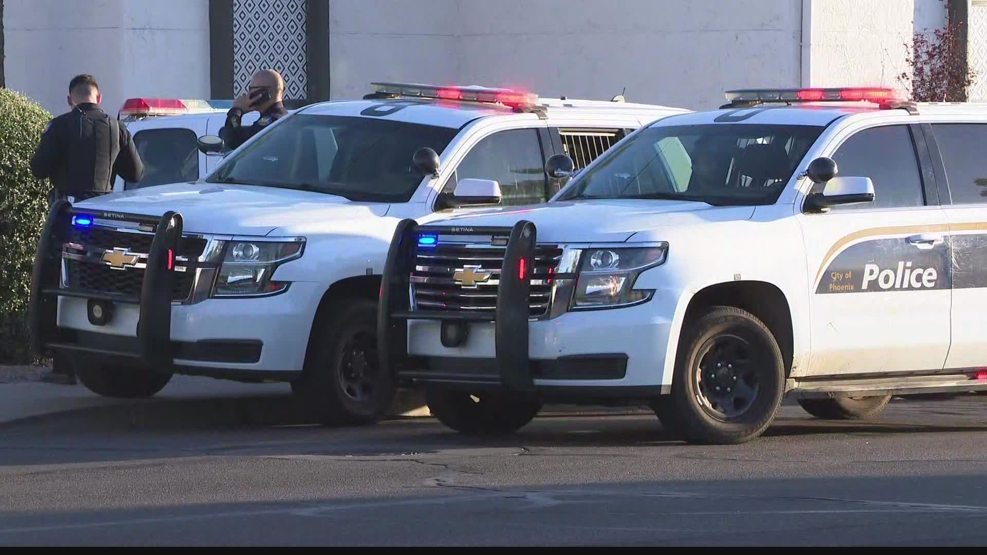 A domestic violence suspect was shot by a Phoenix police officer Monday afternoon after authorities say he was seen armed with a gun.