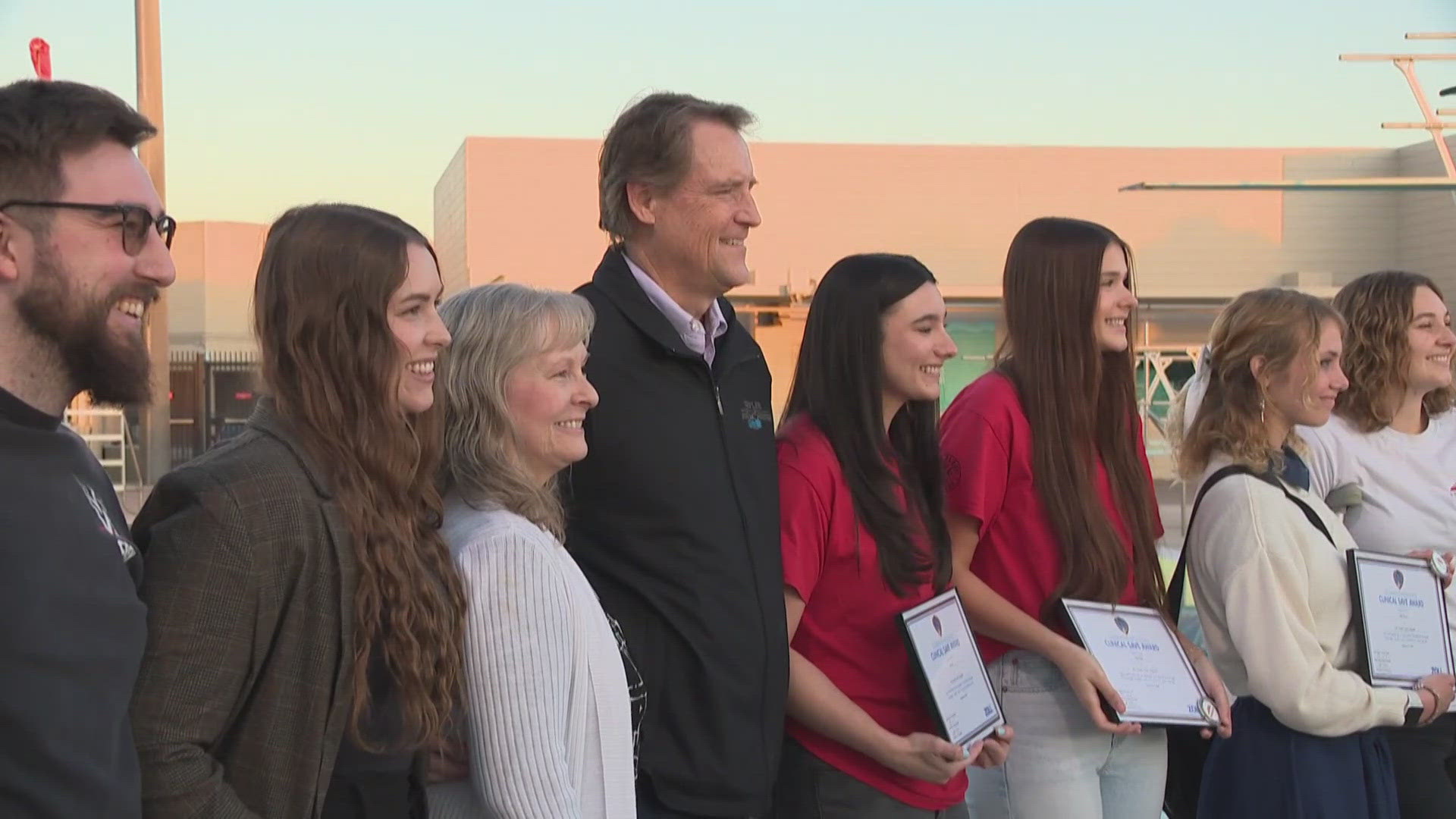 Lifeguards who saved a swimmer in cardiac arrest receive awards for their heroic acts.