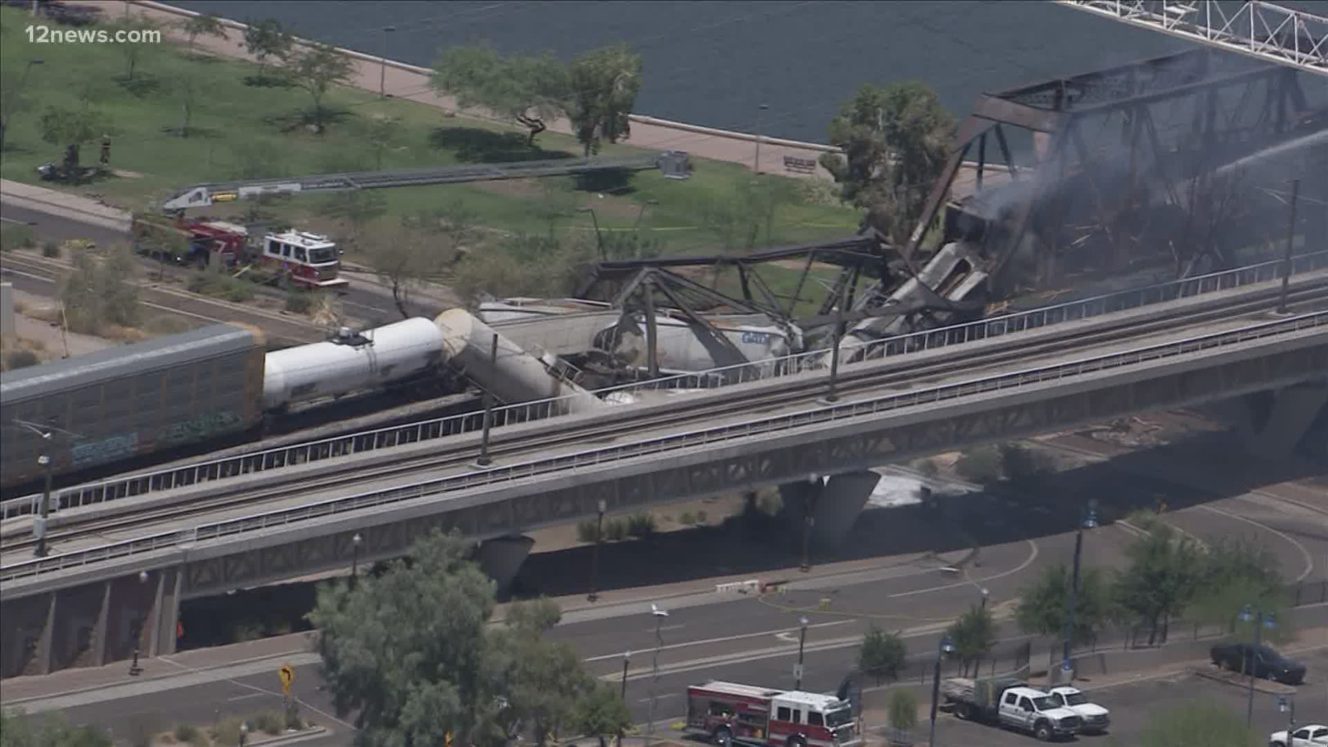 Fire crews were battling a massive fire involving a train on the Tempe Town Lake bridge early Wednesday. Heavy smoke was seen over Tempe Town Lake by Sky 12.