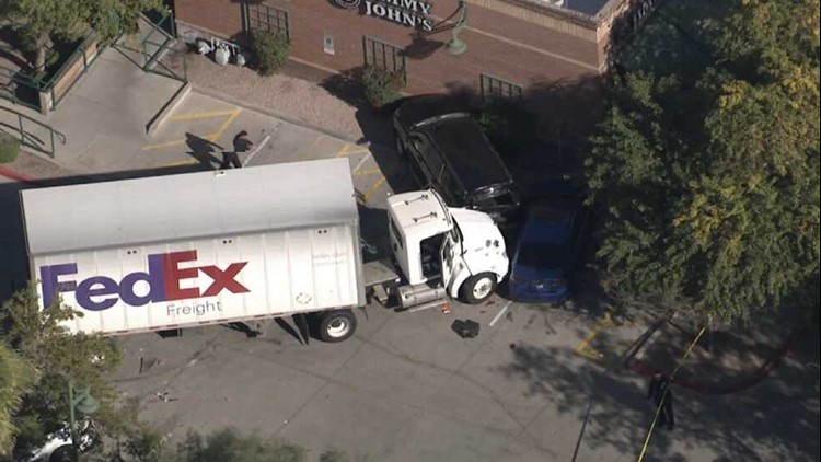 FedEx semi hits several cars in restaurant parking lot, 1 critically injured