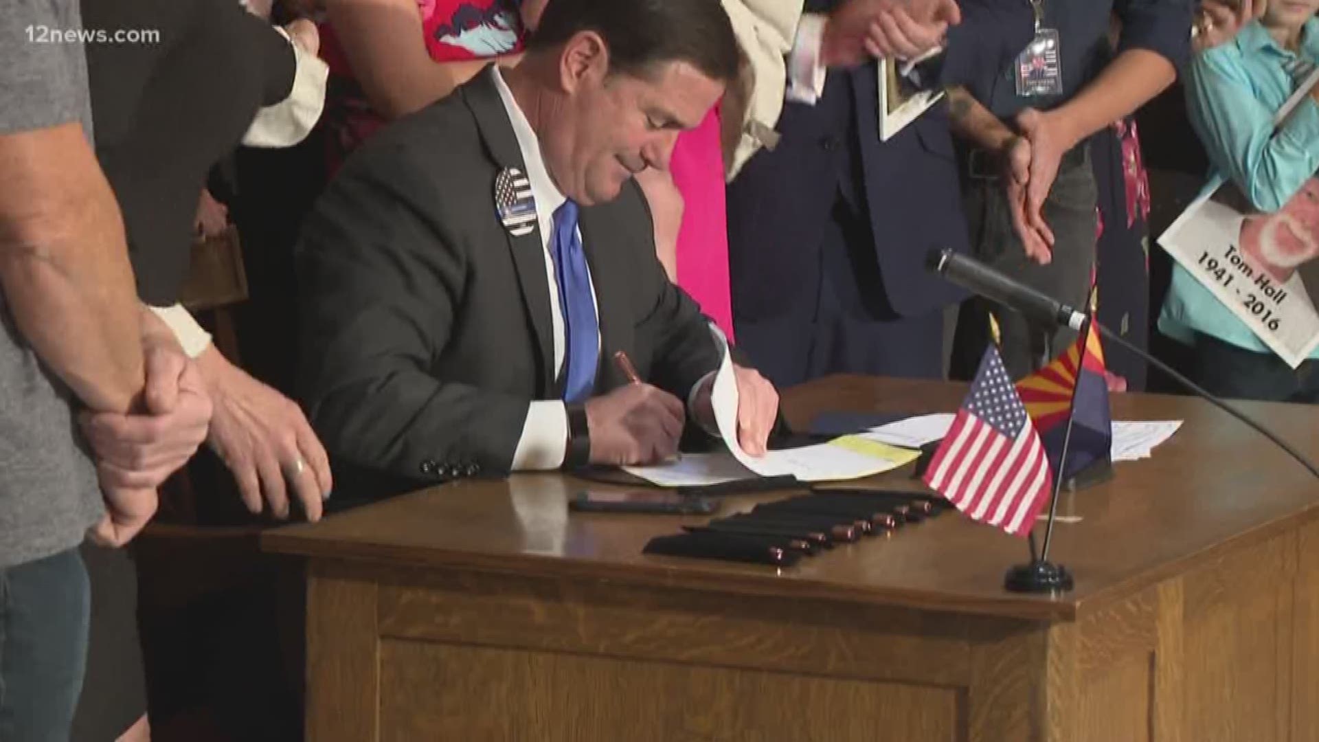 Arizona Governor Doug Ducey signed a bill banning texting and driving Monday. Officer Clayton Townsend's family, along with other families who had a loved one killed by a distracted driver, watched on as the governor signed the bill into law.