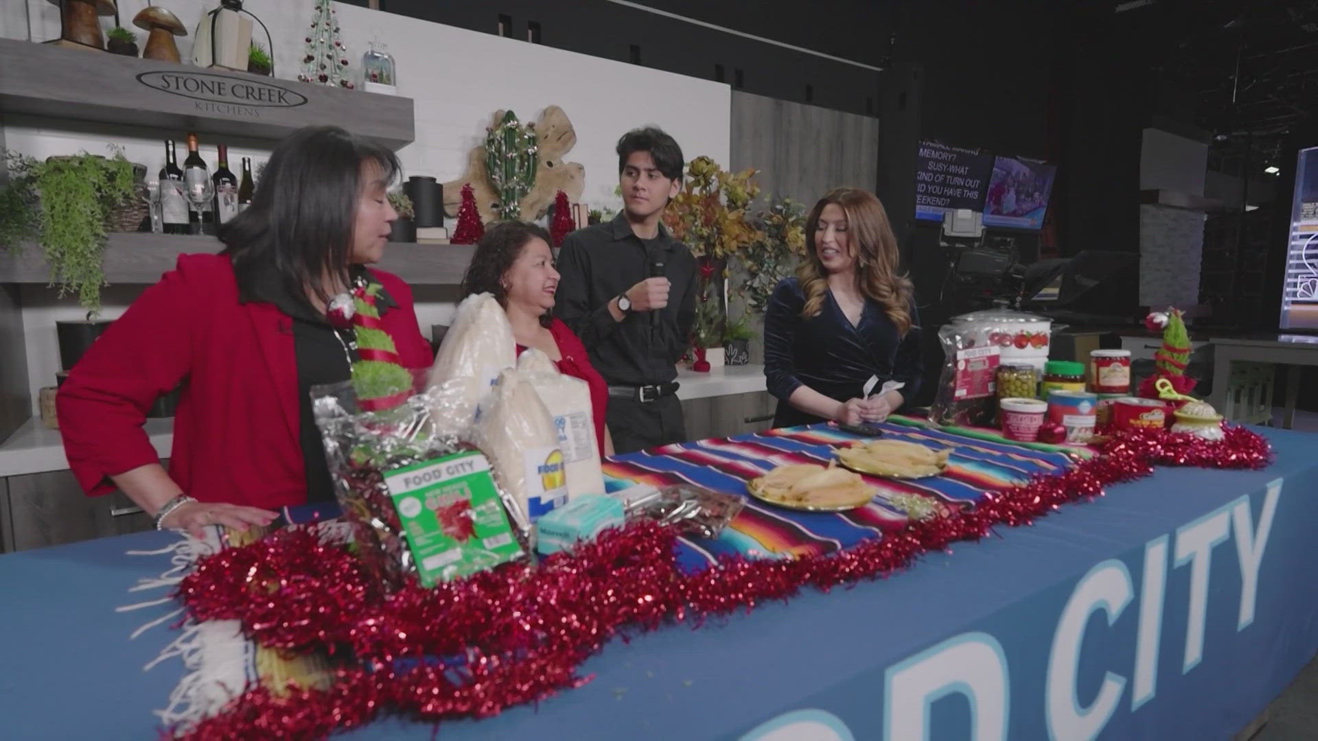 Allison Rodriguez talks with a mother and son who competed in the annual Food City tamale-making contest.