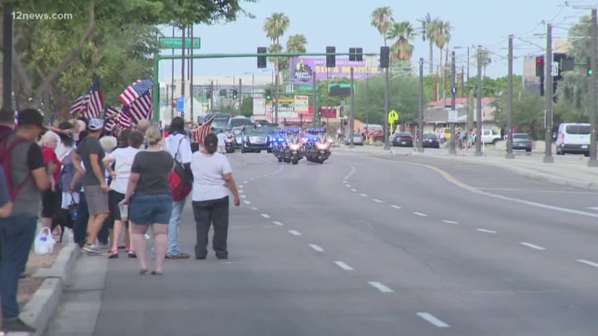 As his body made it's way through the streets of Phoenix, heading to North Phoenix Baptist Church for memorial services, citizens came out with flags and flowers to pay tribute to John McCain.