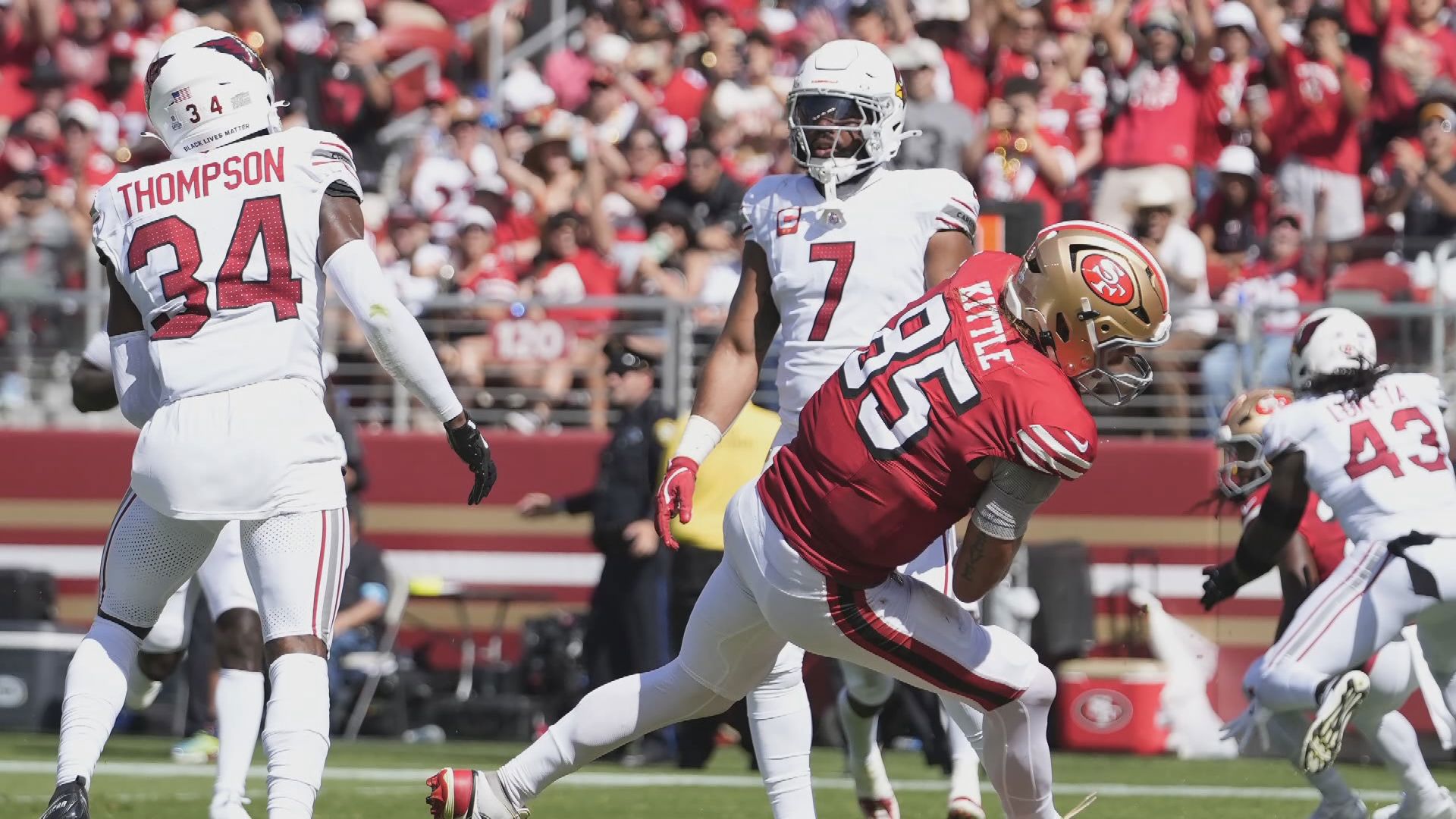 Cam Cox talks with Cardinals linebacker Kyzir White after Arizona's 24-23 win in San Francisco.