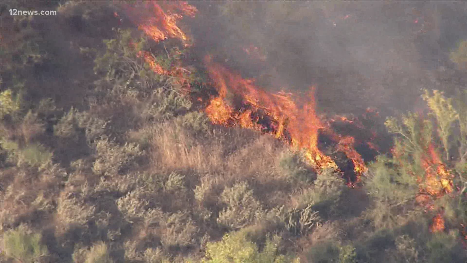 The East Desert Fire, which was burning near 24th Street and Desert Hills Drive, quickly spread to hundreds of acres Sunday afternoon, fueled by wind through dry gra