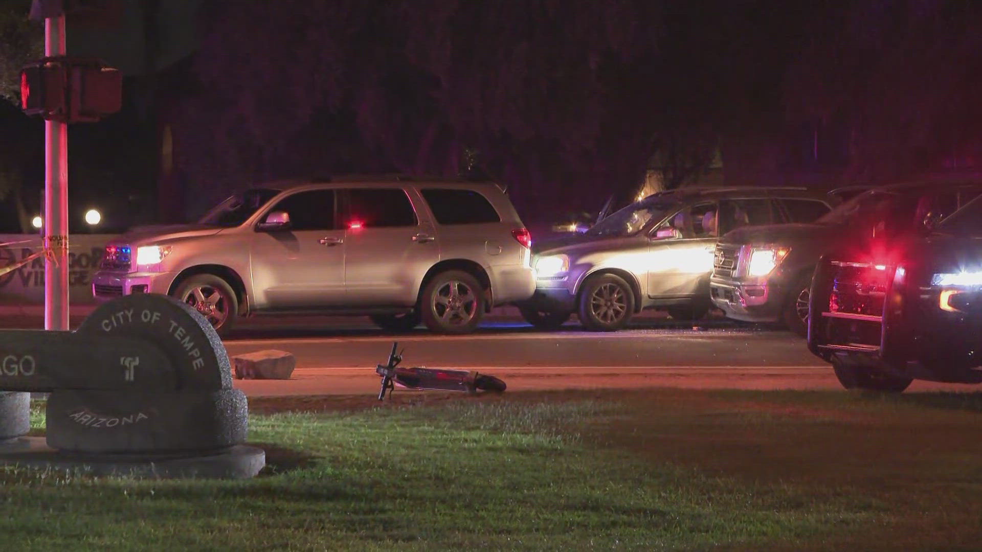 Law enforcement officers appeared to be covering a body with a tarp at the scene.