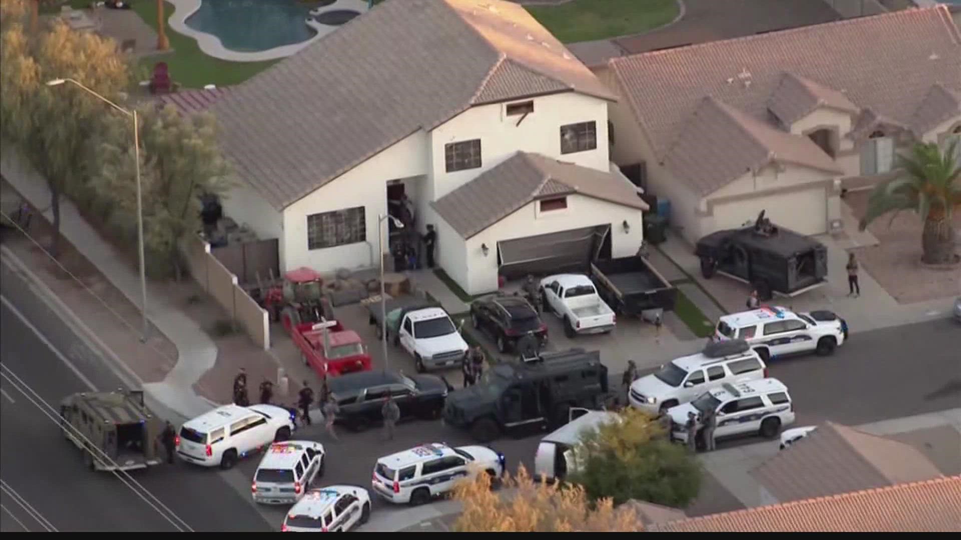 Phoenix police swarm a home in the north Valley after a man opens fire on officers.