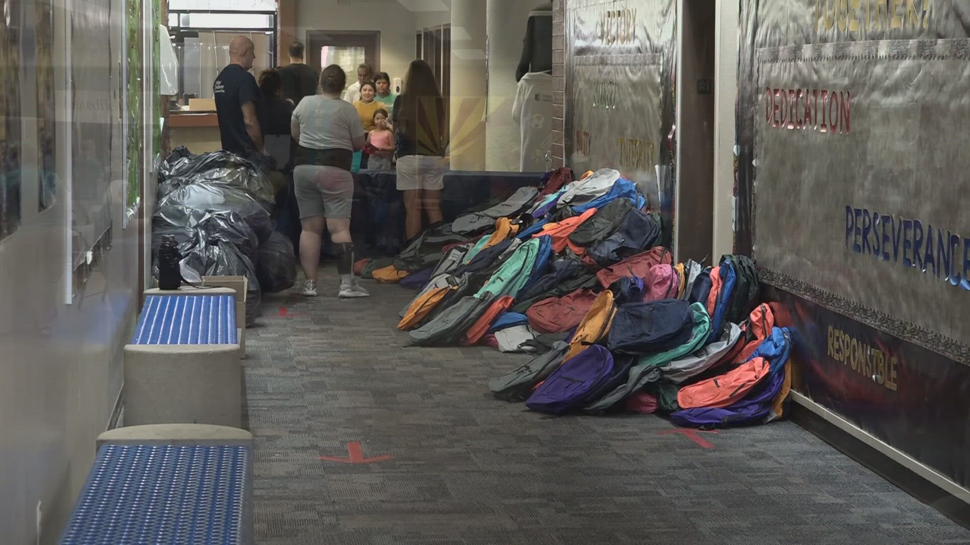 Backpacks and other school supplies piled up in a hallway of Isaac Elementary School.