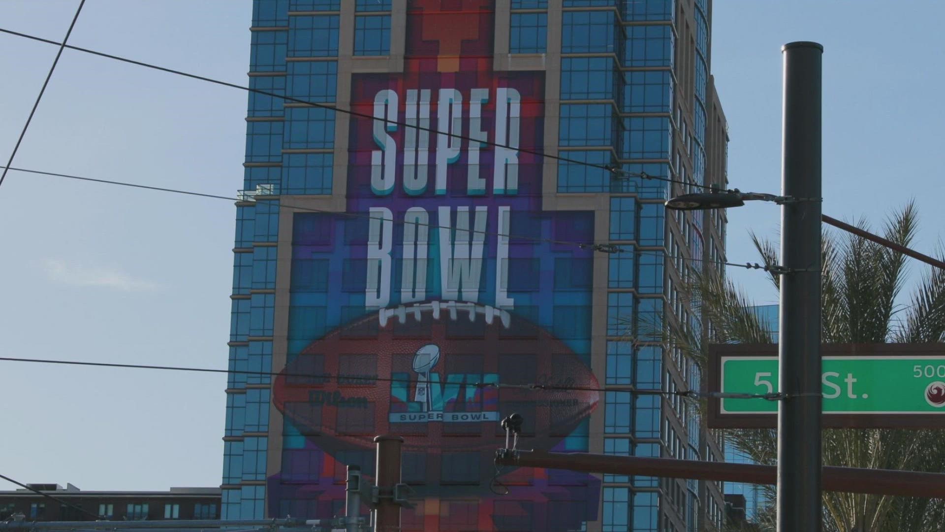 12News takes a behind-the-scenes tour of how massive Super Bowl signs are made.