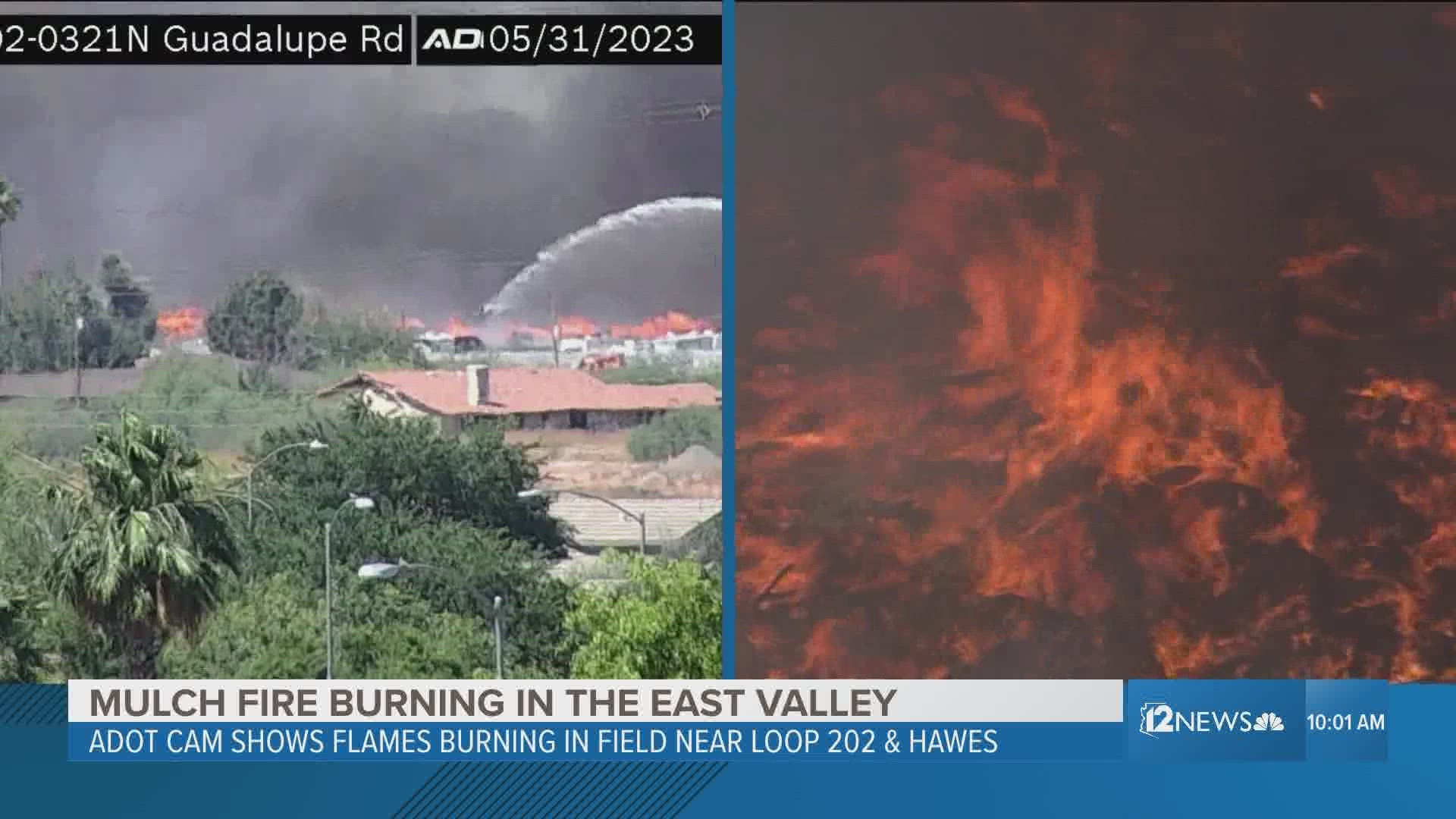 Crews fight a mulch fire Wednesday burning near Loop 202 and Hawes Road near Mesa.