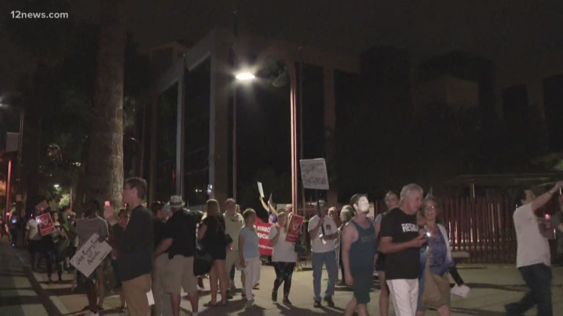 Dozens of protesters shut down a central Phoenix street on Friday night over reported ICE raids across the country.